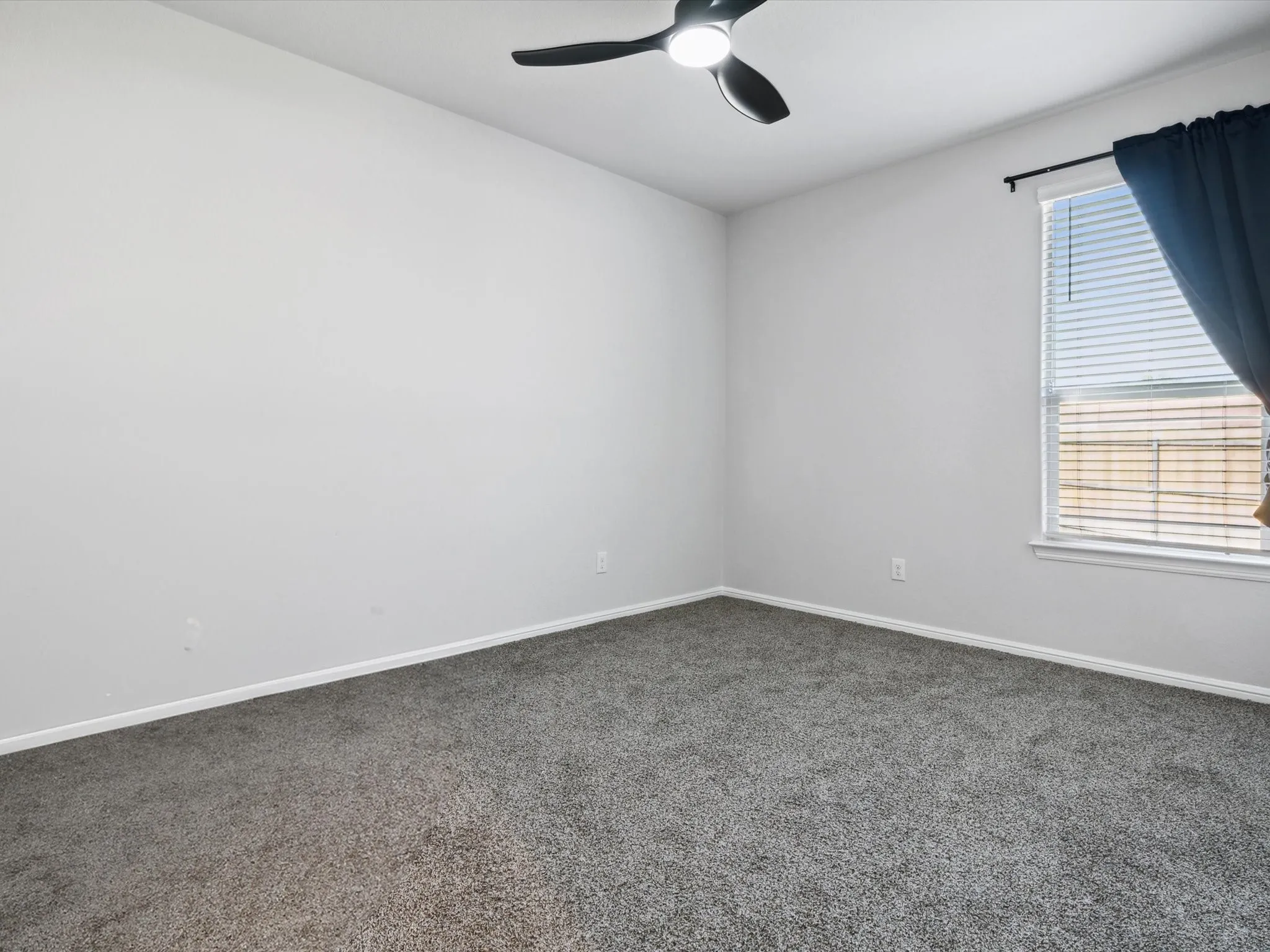 Neutral-toned walls complement the gray carpeting