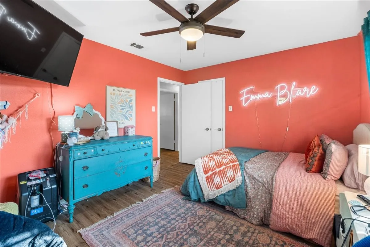 Wood-finish flooring with a ceiling fan light fixture