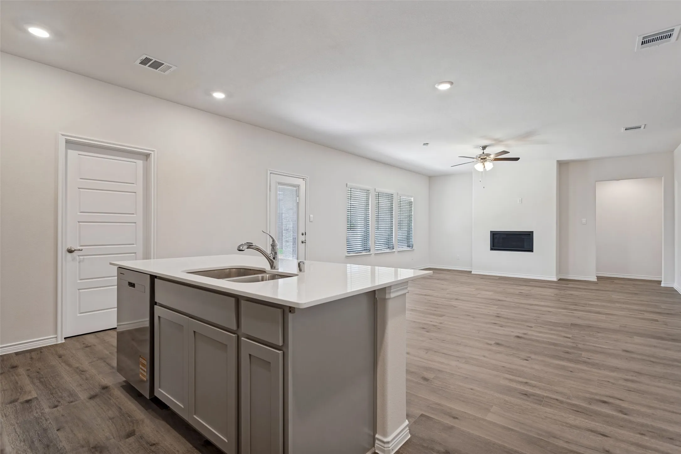 Kitchen island with a double basin sink and a stainless steel dishwasher