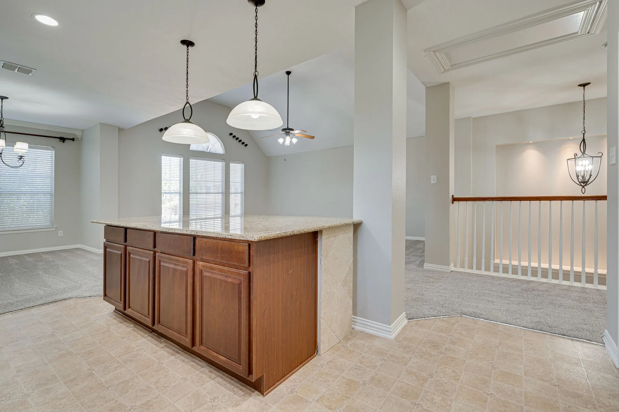 Kitchen features decorative lighting and open to living and dining room!