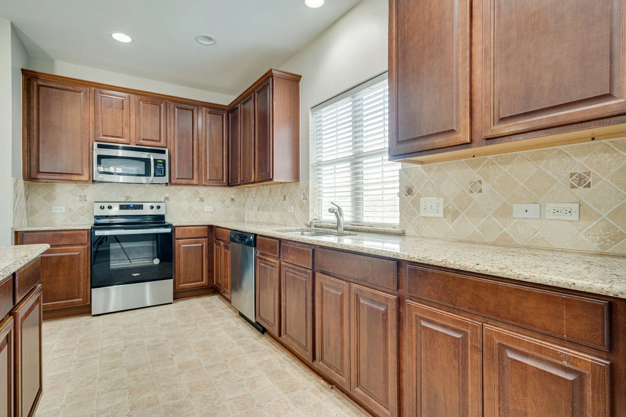 Kitchen features tons of cabinets and granite countertops