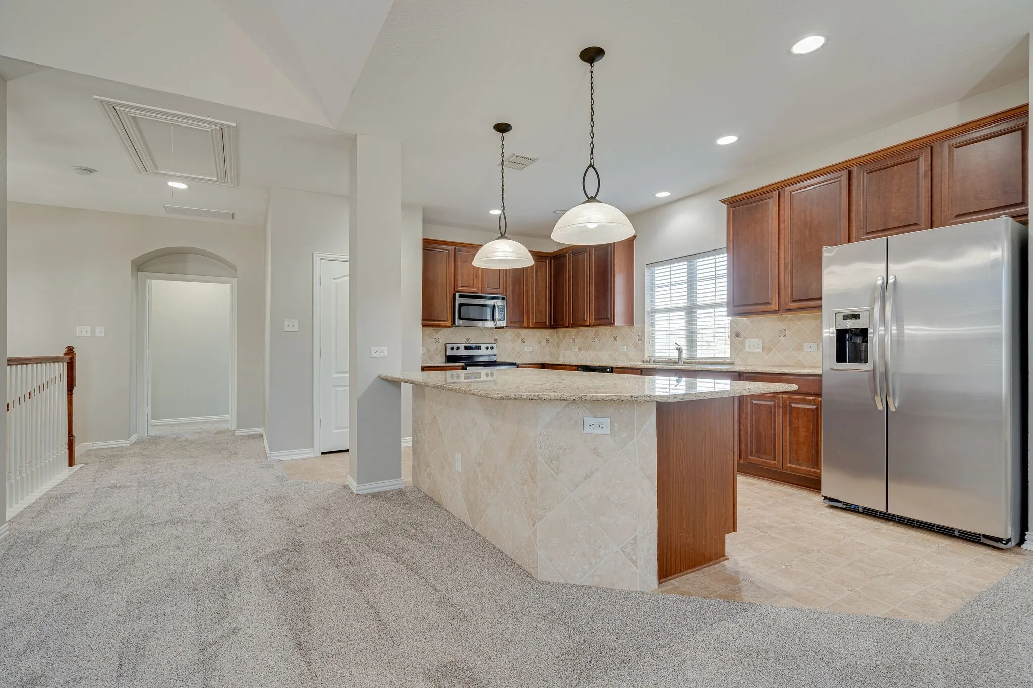 Kitchen with stainless steel appliances and large island
