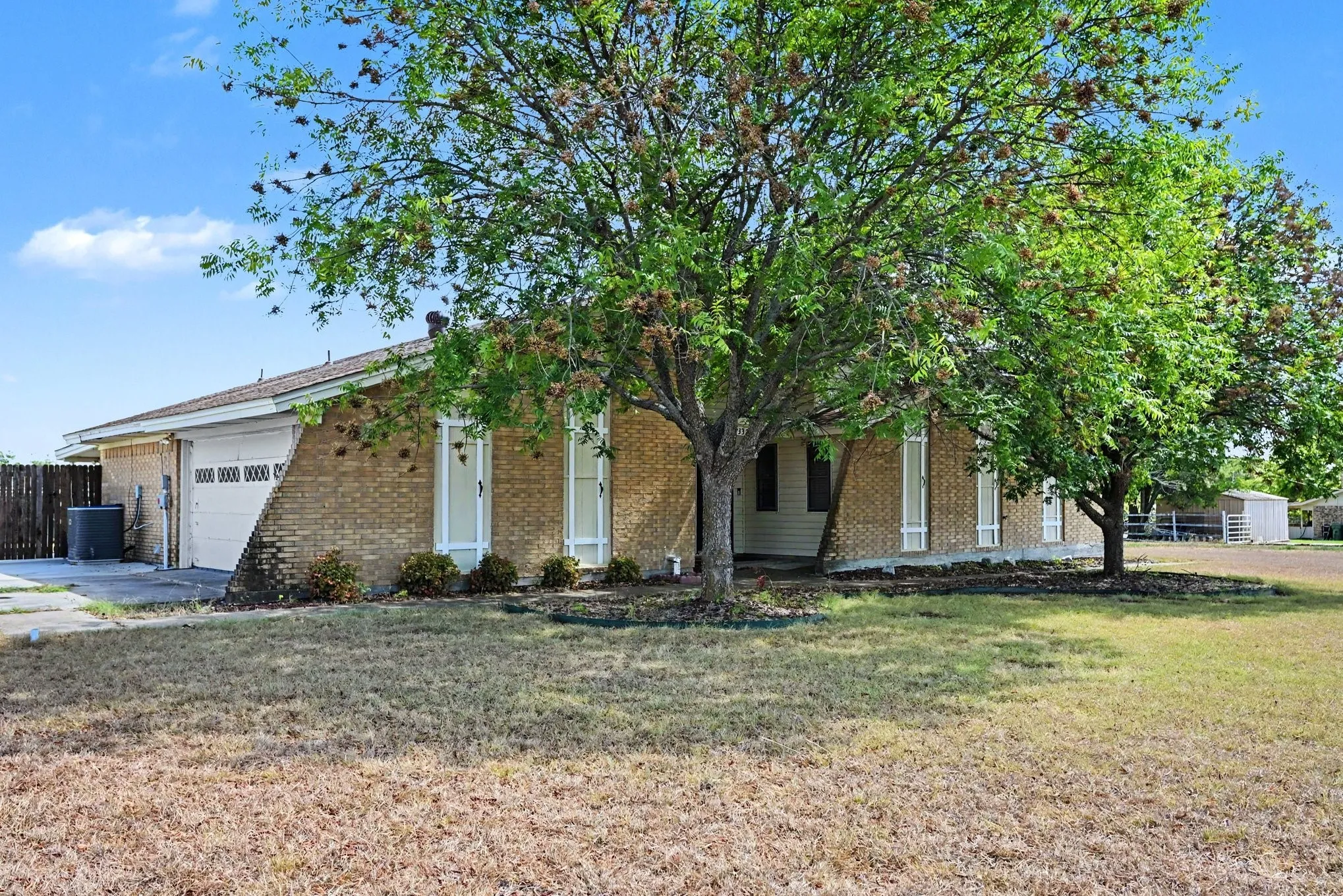 Brick exterior with a single-car garage and a paved driveway