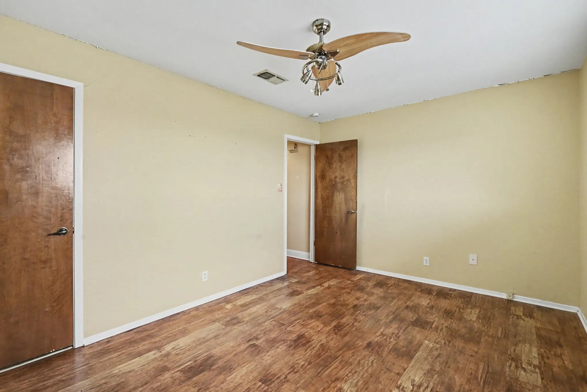 Wood-finish flooring with a ceiling fan light fixture