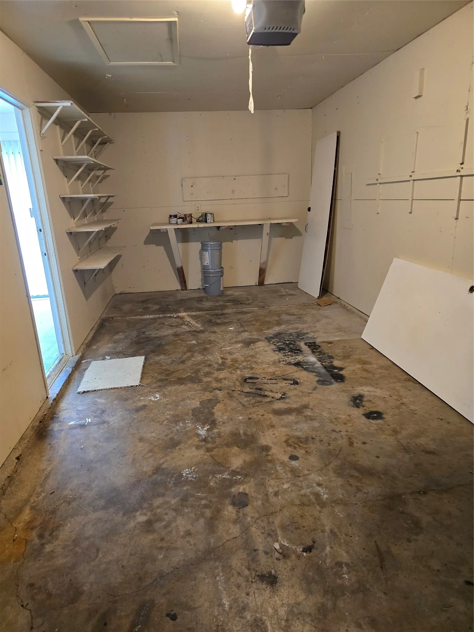 One car garage with small workspace and some storage