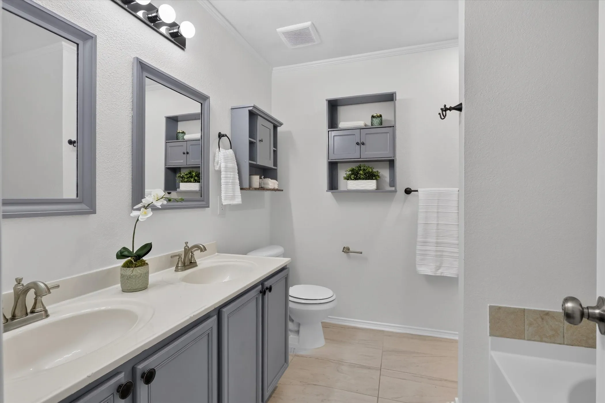 Dual vanity with integrated sinks, framed mirrors, and brushed nickel fixtures