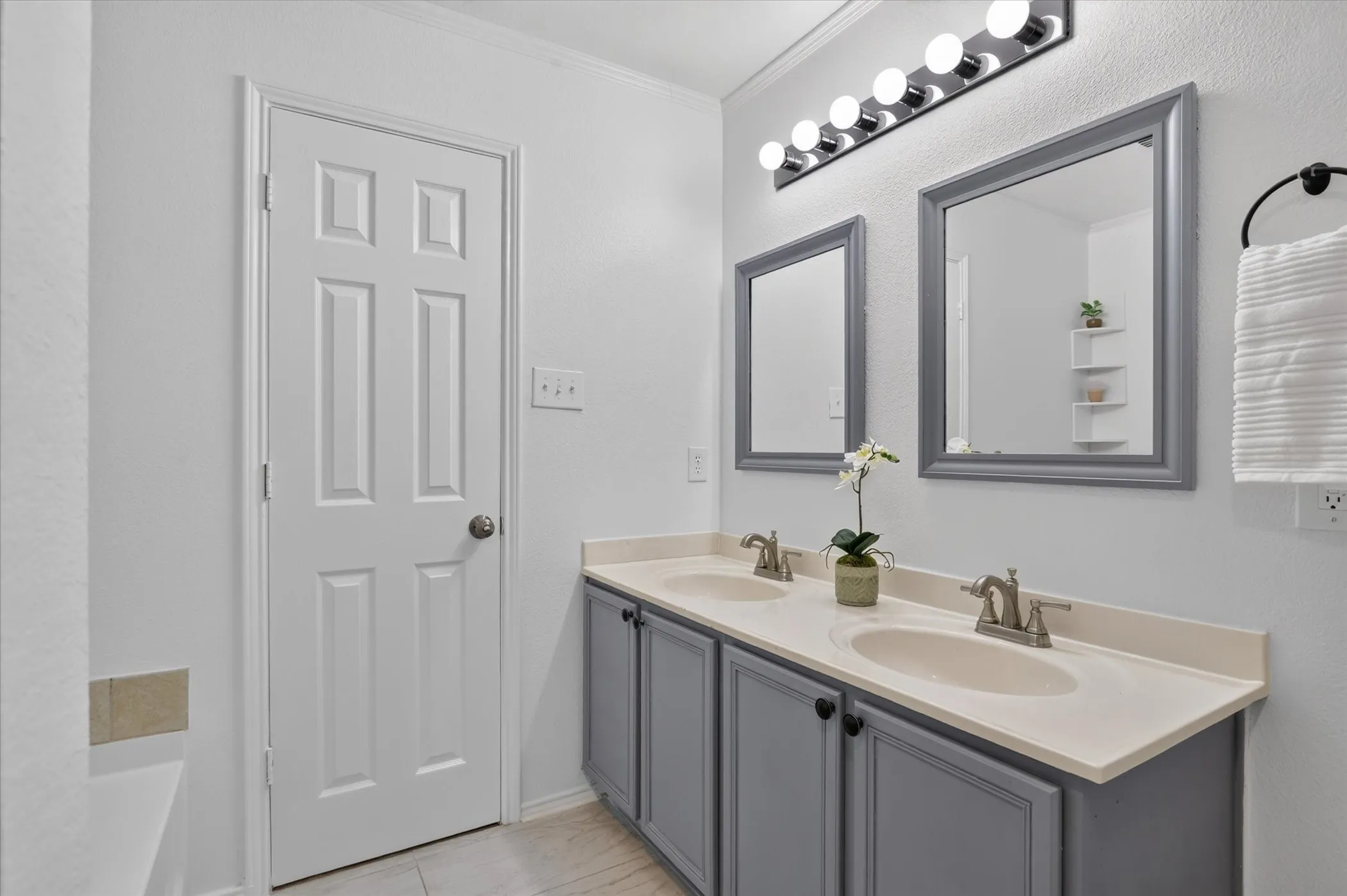 Dual vanity with light-colored countertops, undermount sinks, and brushed nickel fixtures