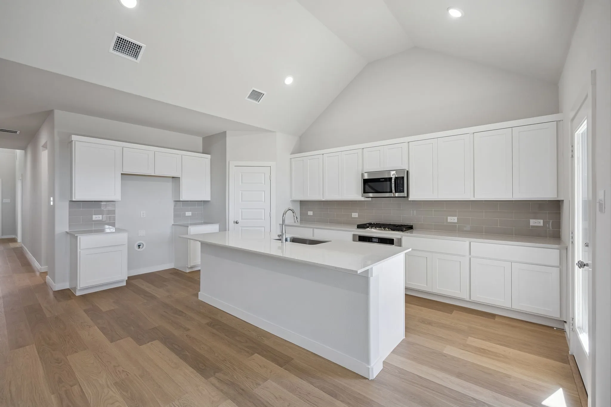Kitchen in the Wimbledon home plan by Trophy Signature Homes – REPRESENTATIVE PHOTO