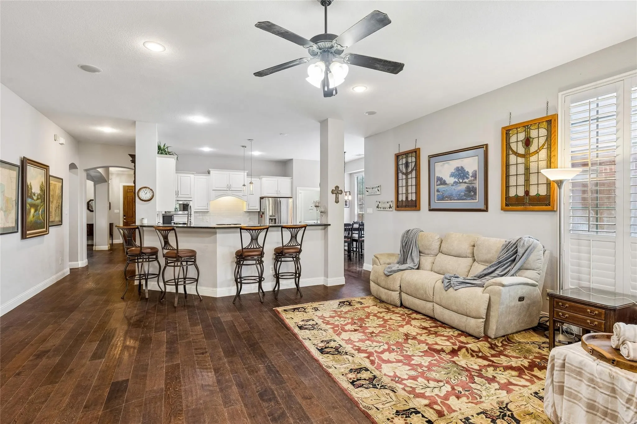 Wood-finish flooring throughout, with recessed lighting and a ceiling fan