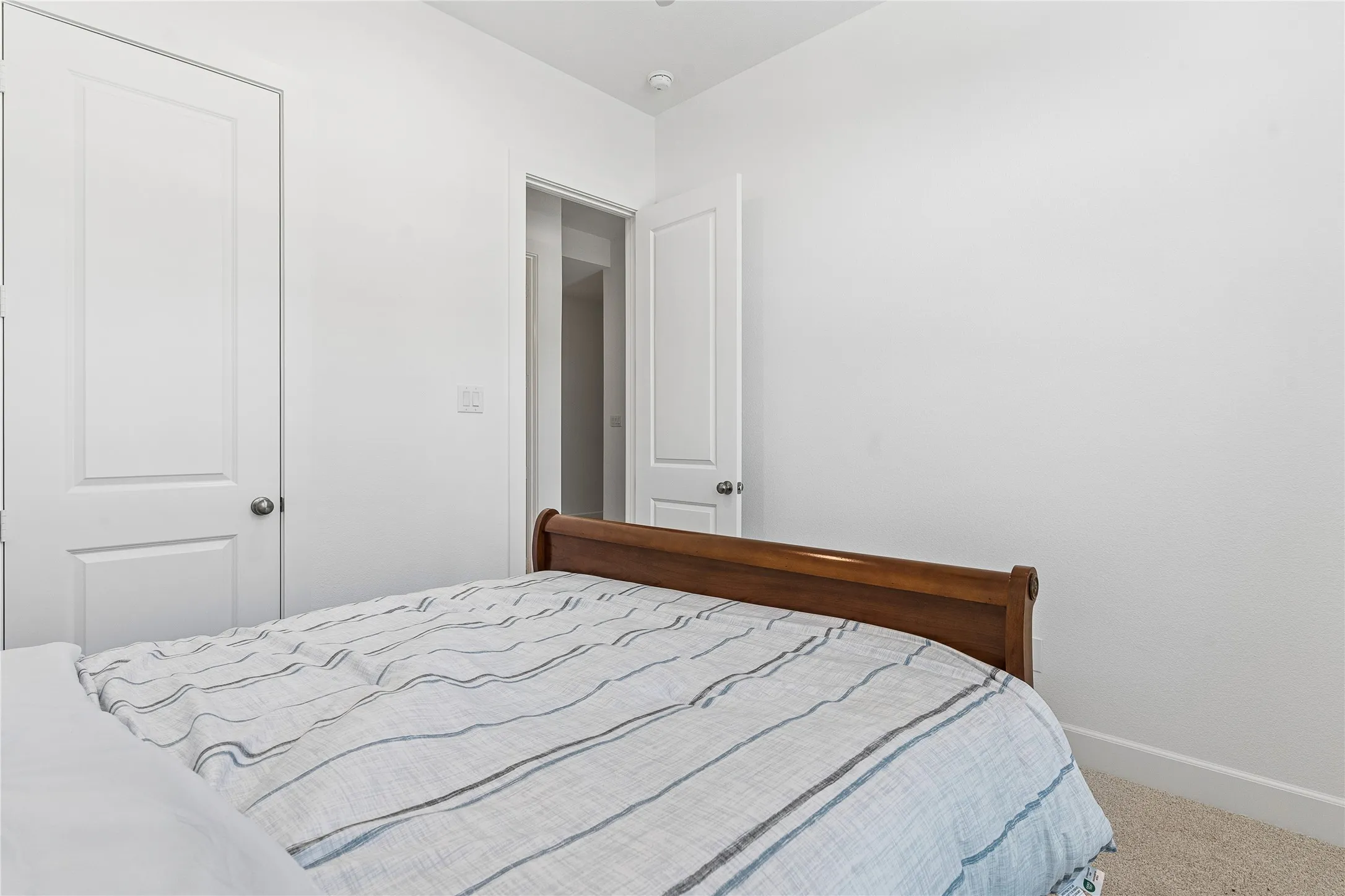 Carpeted flooring, white walls, and white trim