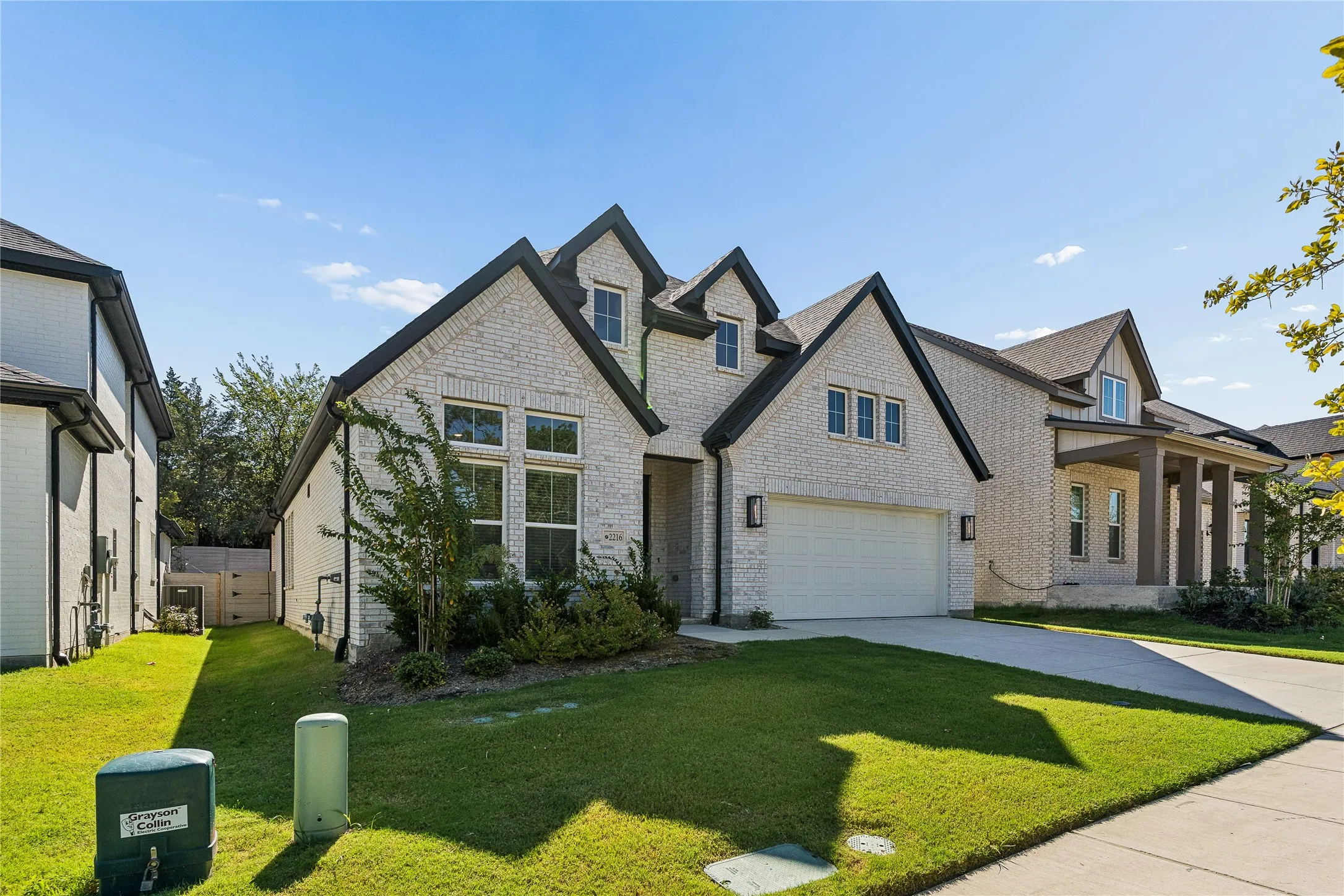 Brick facade with black trim accents and multiple gables