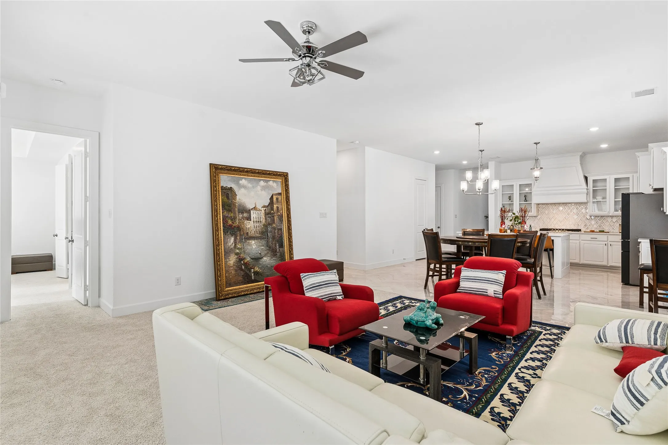Open concept living area with recessed lighting, ceiling fan, and carpeted flooring