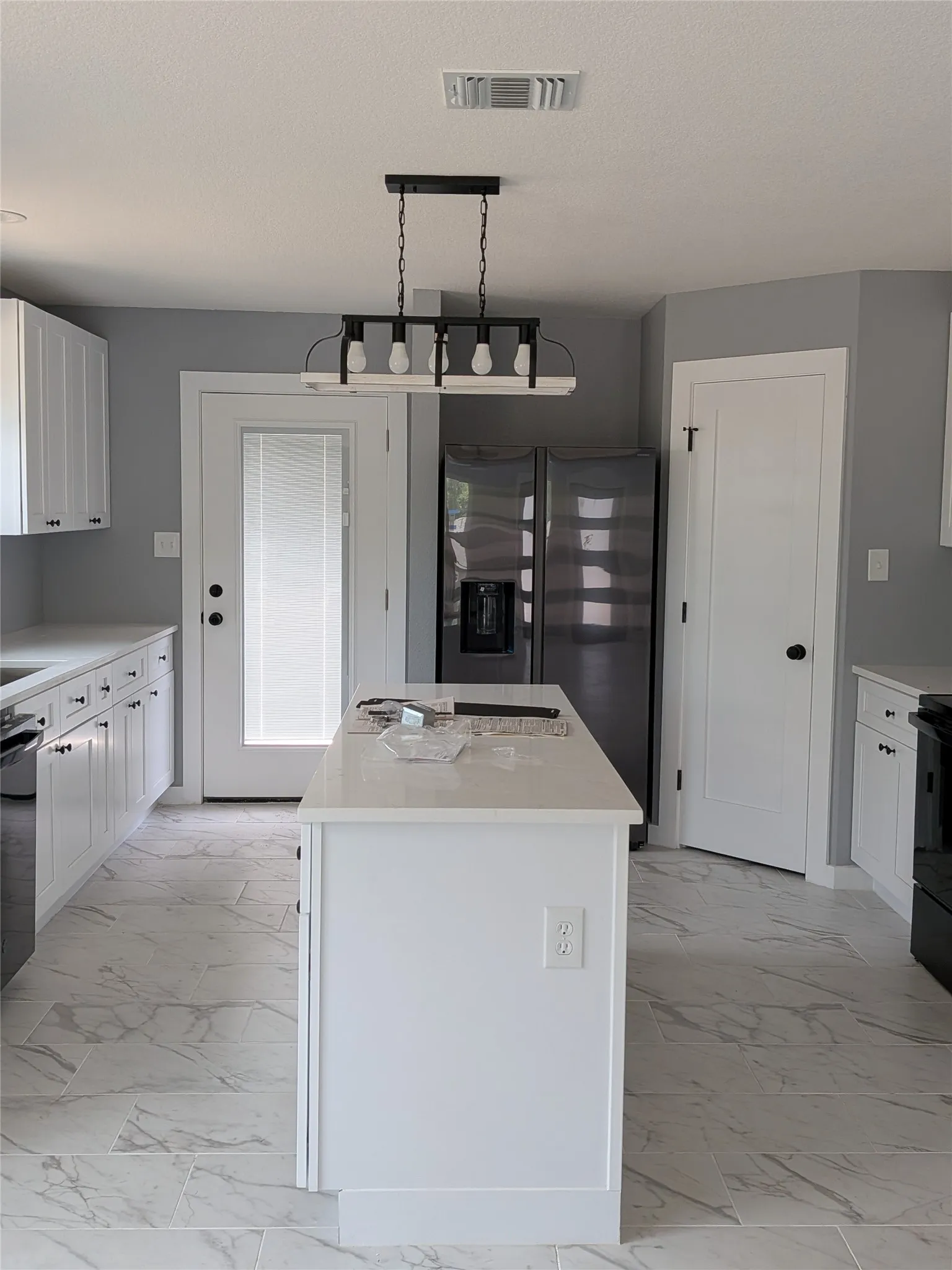 KITCHEN WITH MARBLE COUNTER TOPS AND ISLAND