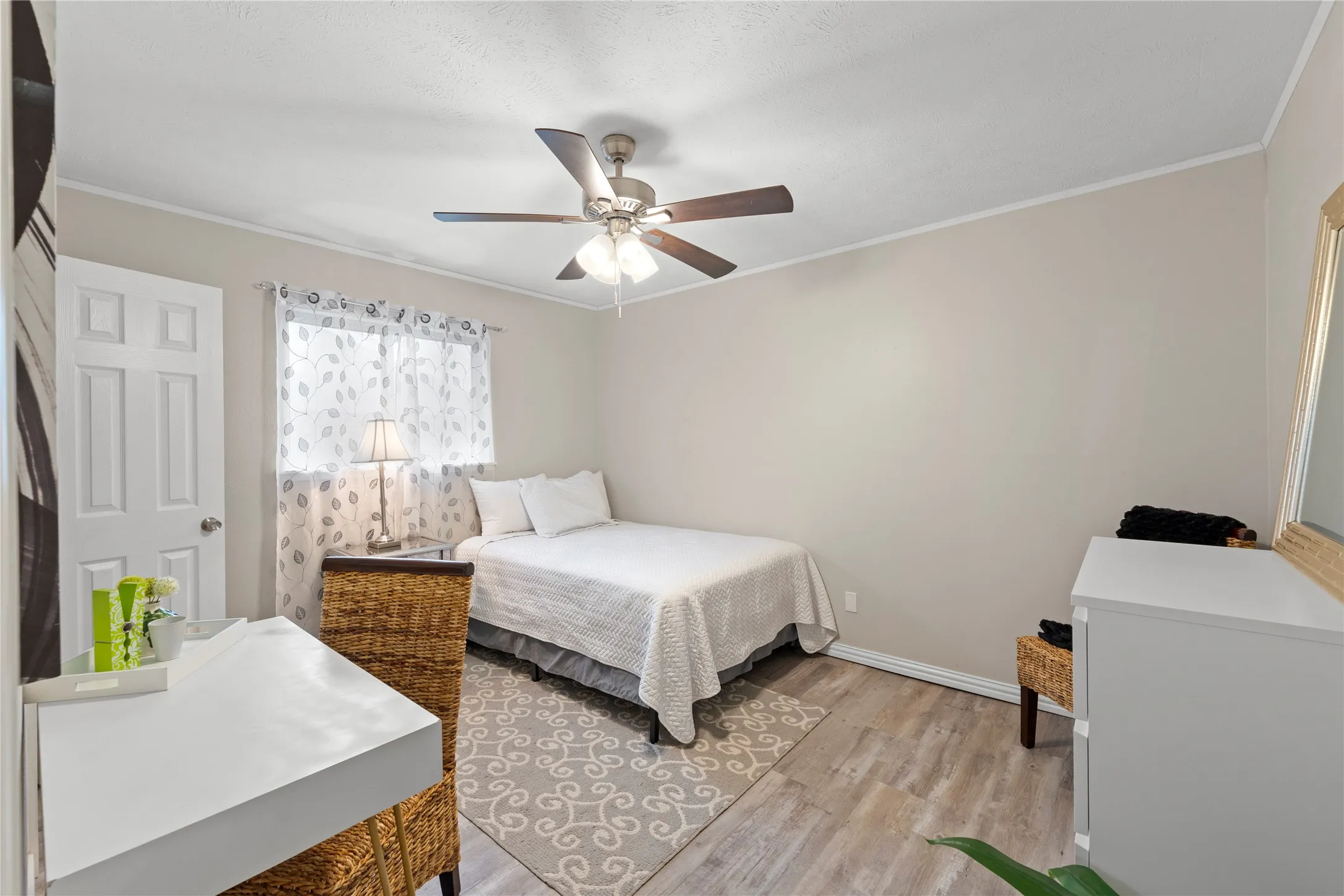 Recessed lighting, ceiling fan with light fixture, wood-finish flooring, white paneled door, and window with sheer curtains