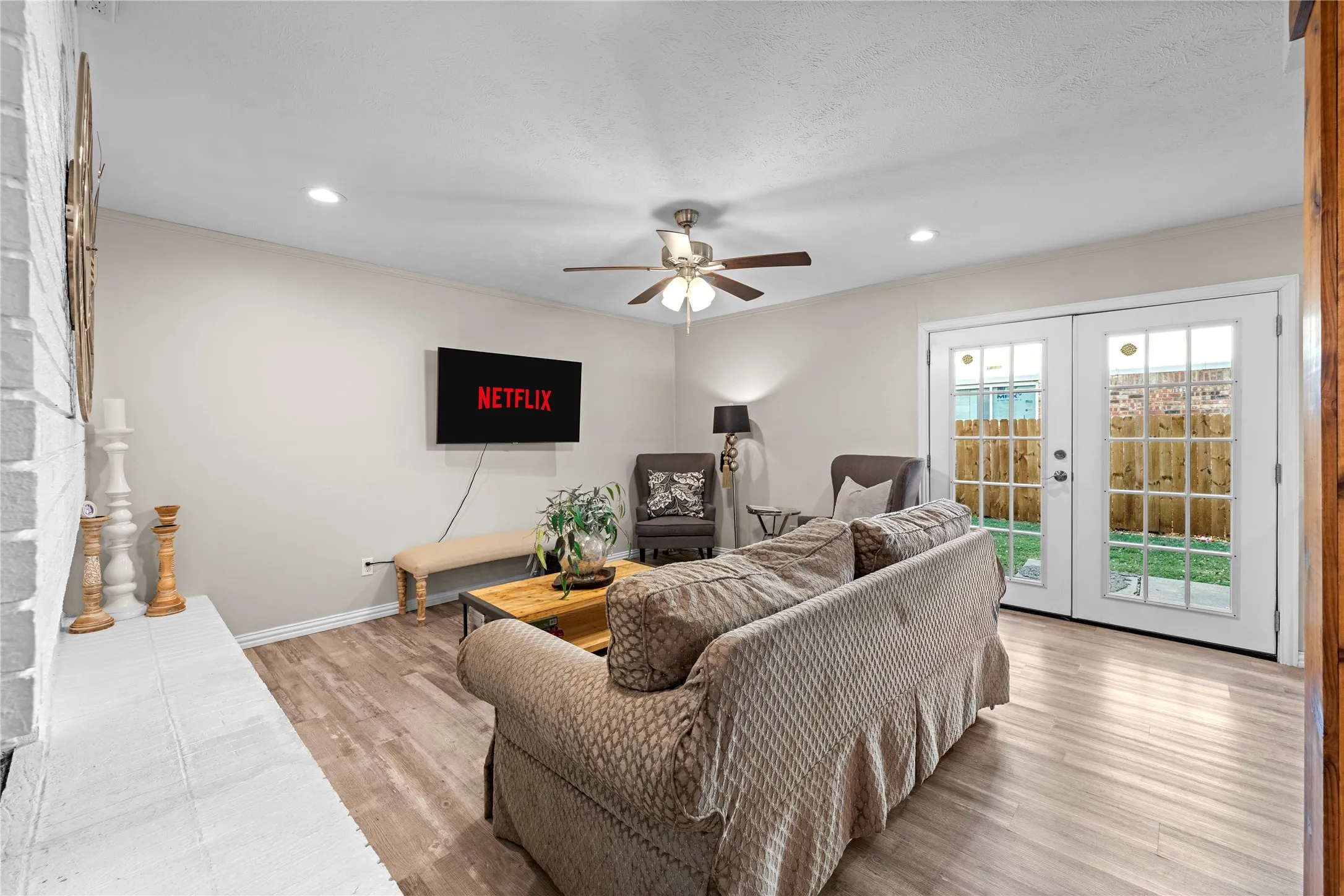 Living space featuring wood-finish flooring, recessed lighting, and a ceiling fan