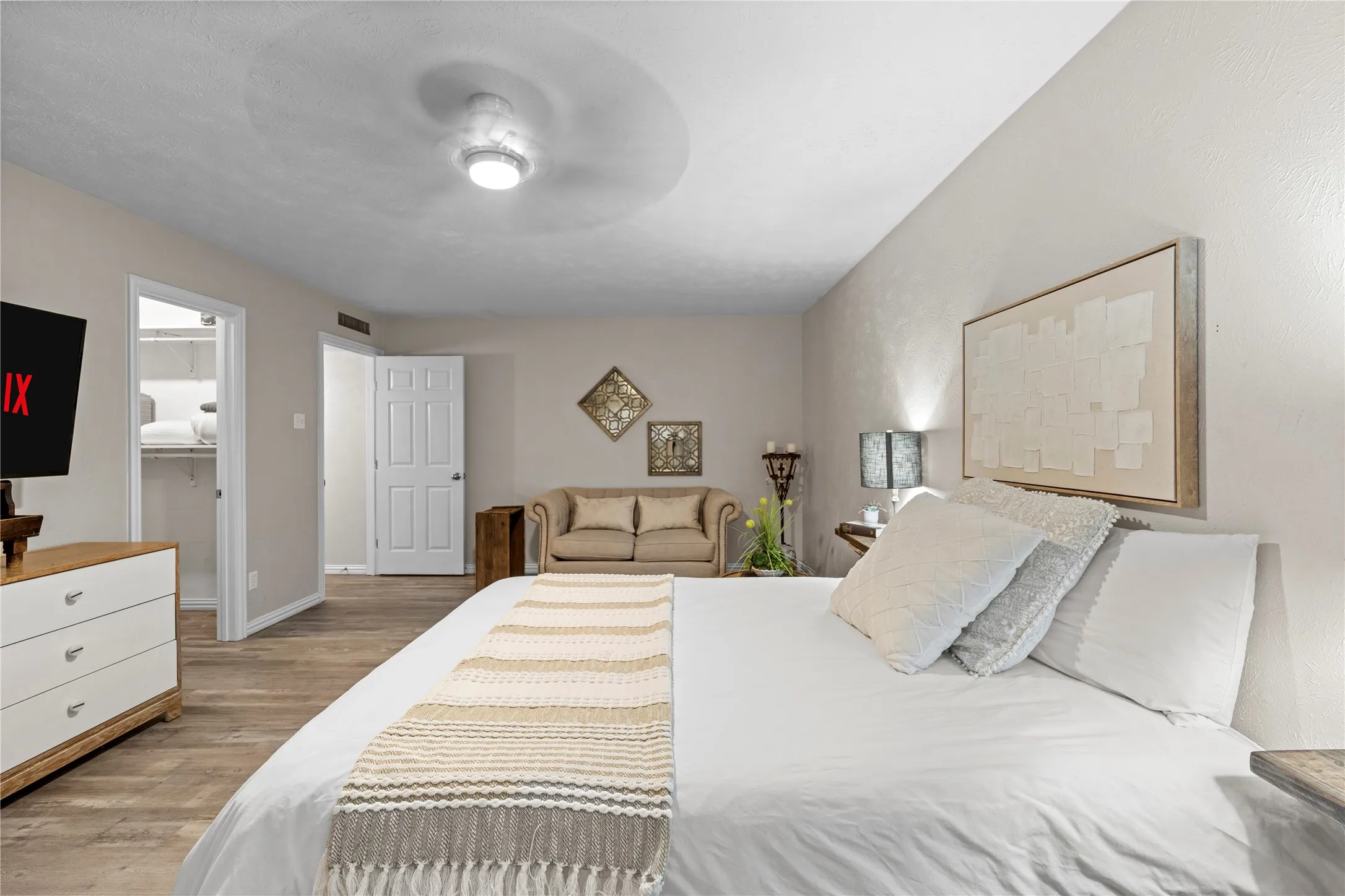 Recessed lighting, wood-finish flooring, ceiling fan, and white interior doors