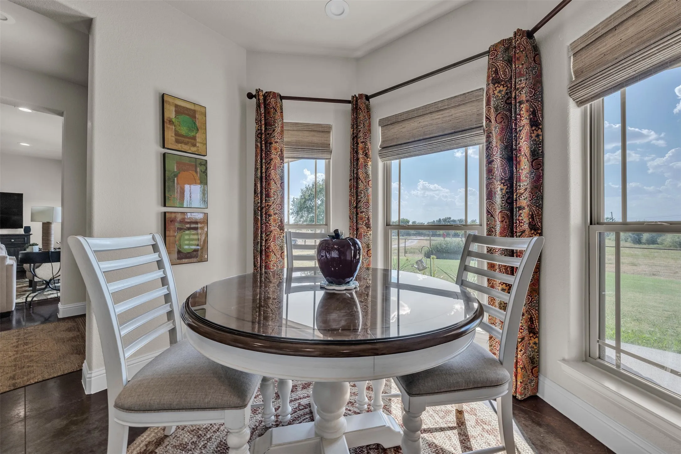 Wood-finish flooring, white trim, recessed lighting, and multiple windows