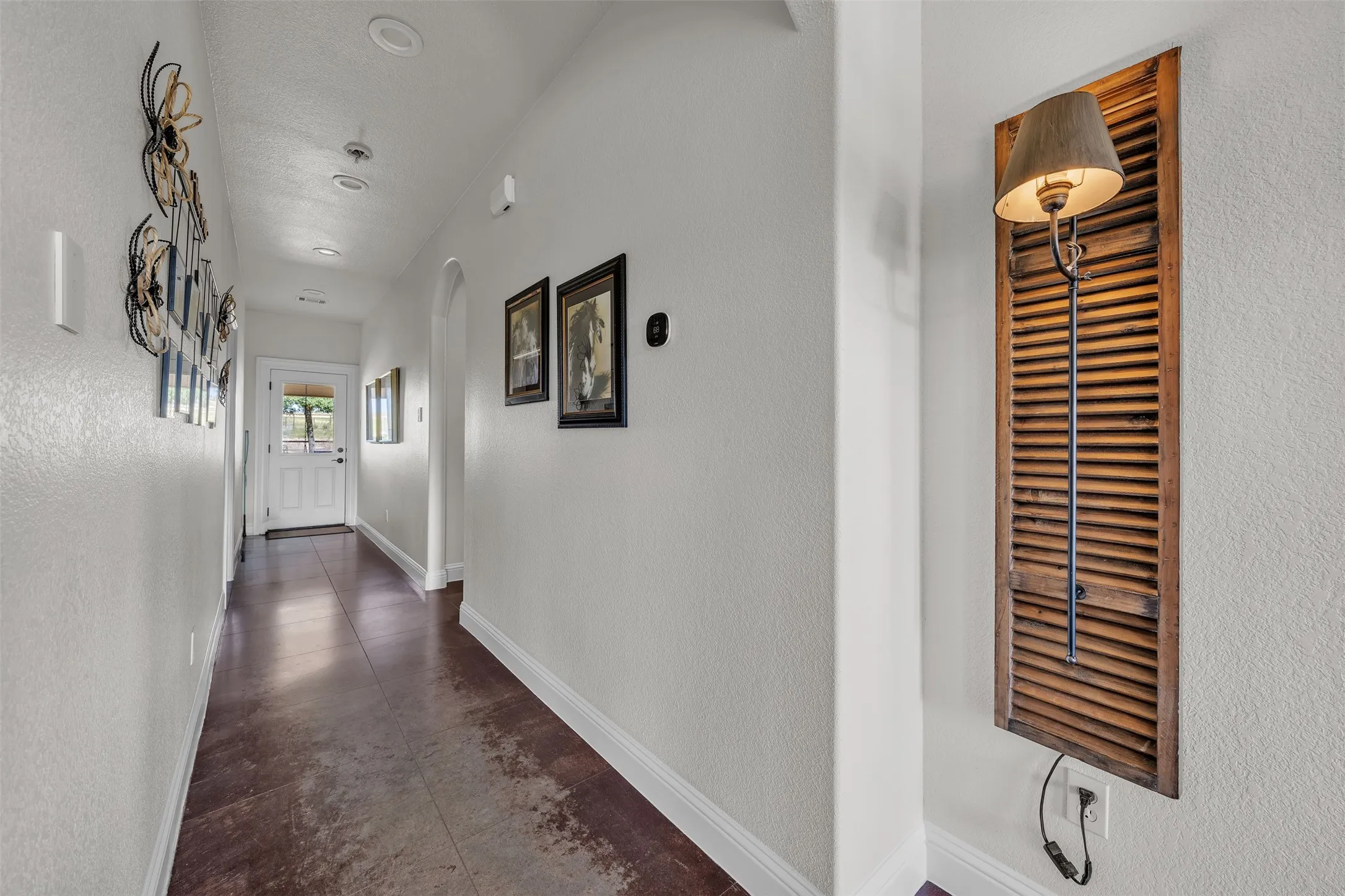 Hallway featuring recessed lighting, a paneled entry door with glass inserts, and wood-finish flooring