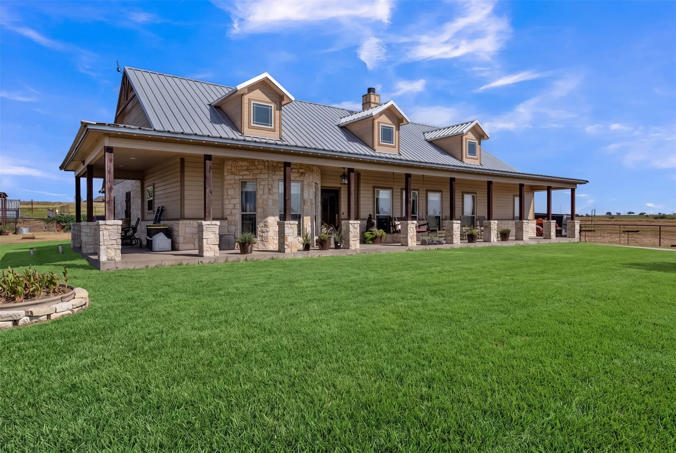 Stone and siding exterior with a metal roof