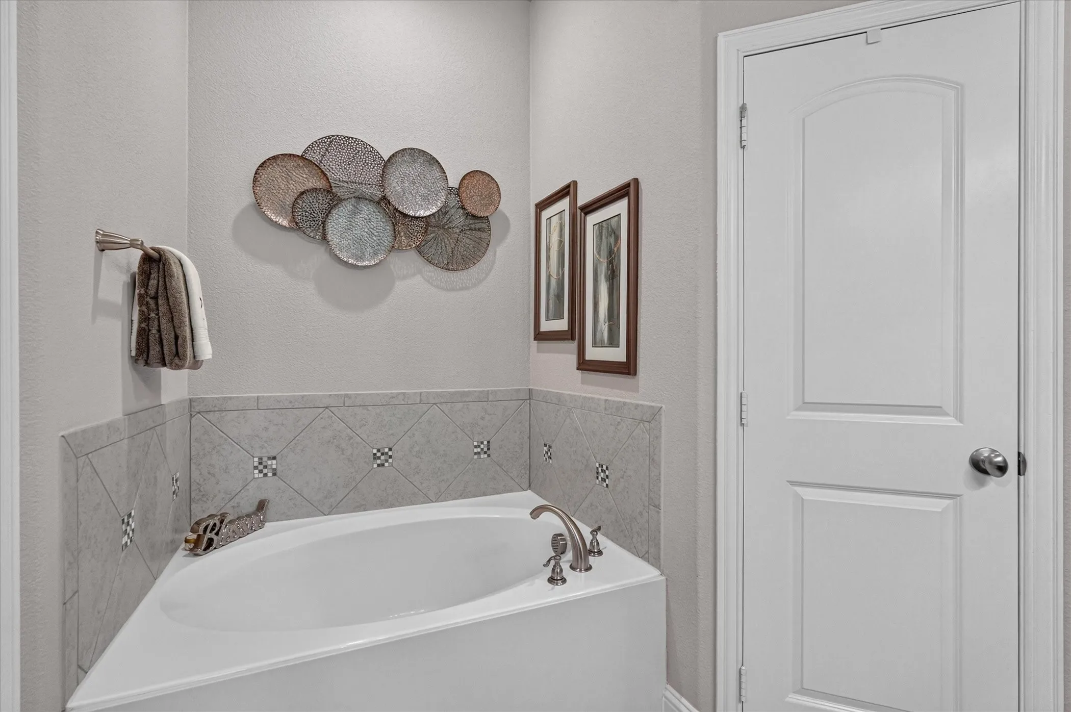 Corner soaking tub with brushed nickel fixtures