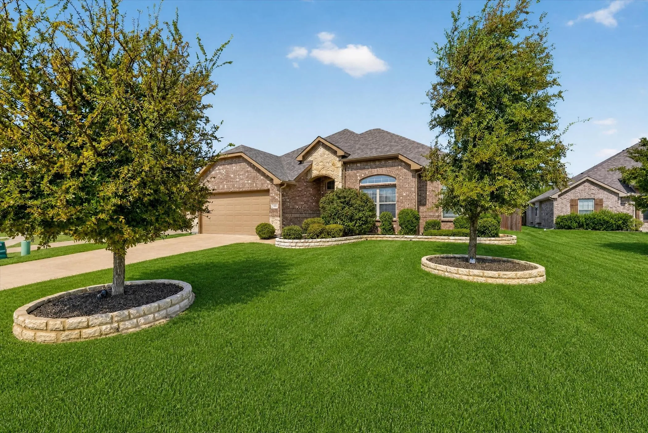 Brick exterior featuring a two-car garage