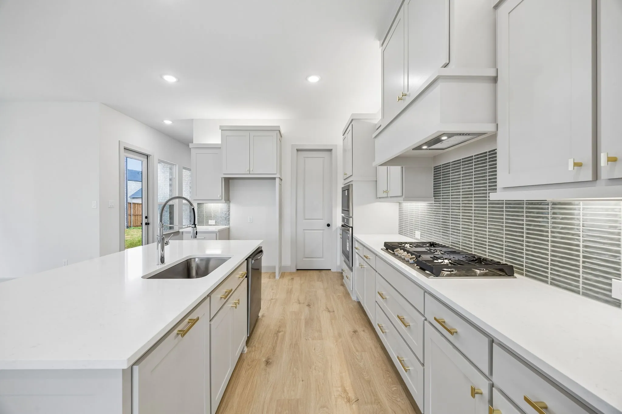 Beautiful cabinetry, gorgeous countertops and designer backsplash effortlessly pair with contemporary stainless steel to create a dream kitchen for the ages!