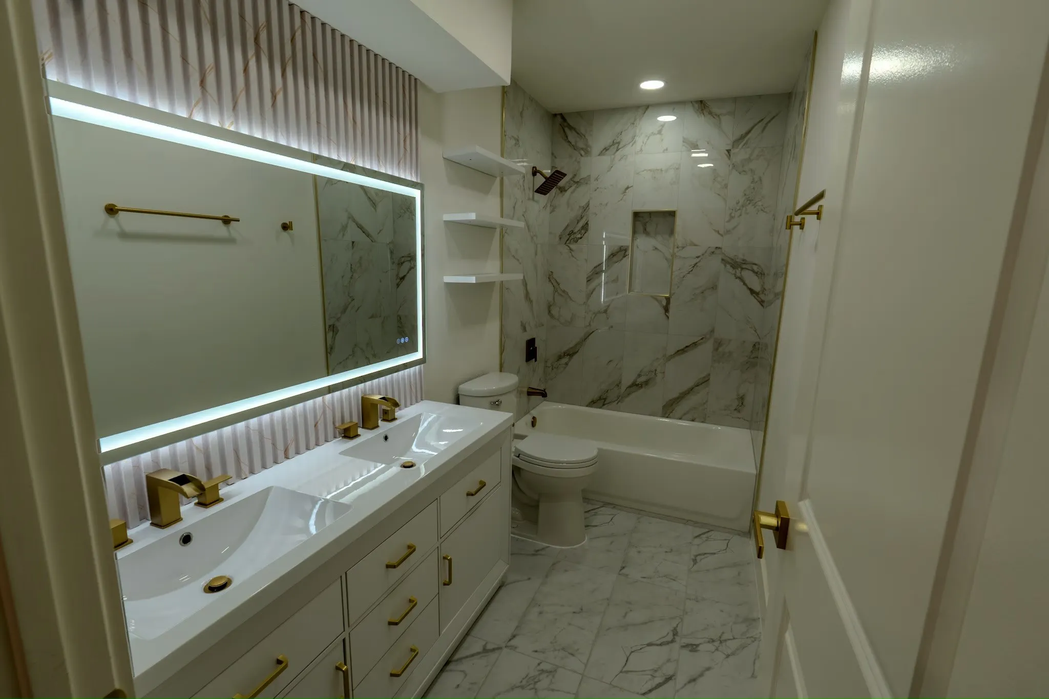 Dual vanity with integrated sinks and gold-finish fixtures