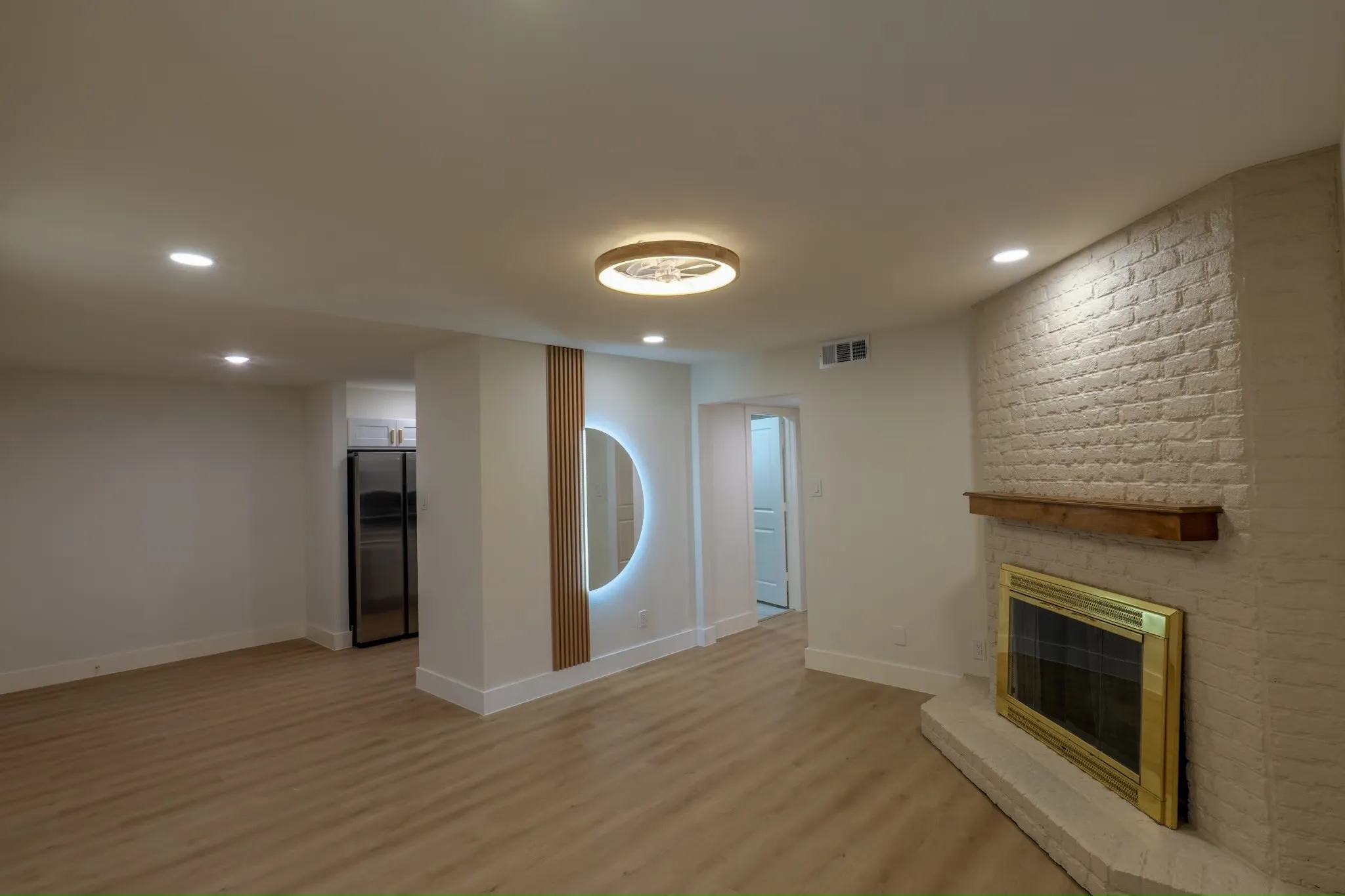 Painted brick fireplace with a wood mantel