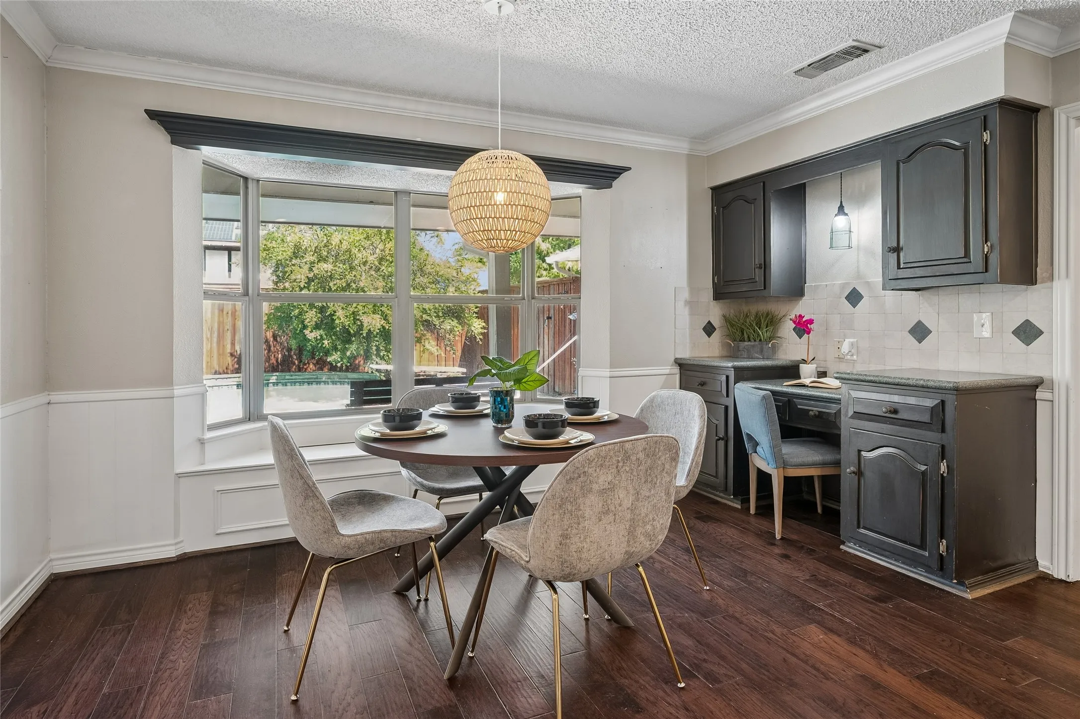 The breakfast room also provides a lovely view of the backyard patio through the bay window.