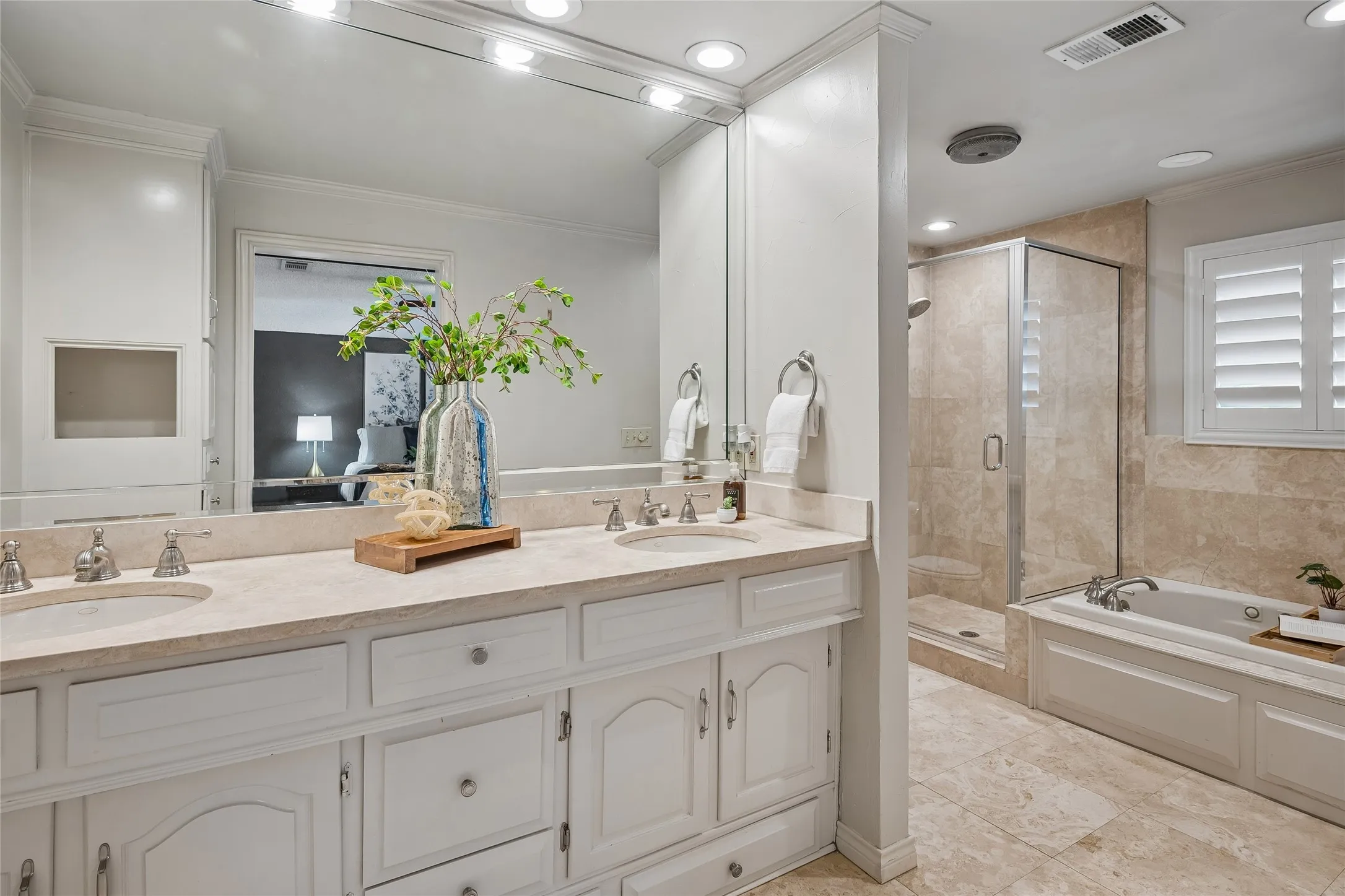 Lovely primary bath with separate shower, jetted tub, and dual lavatories.