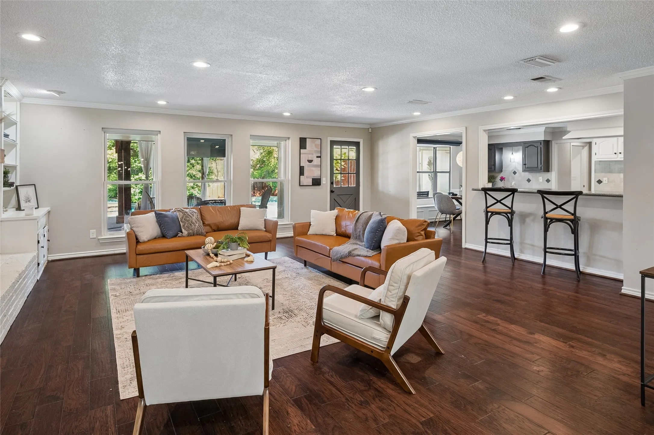 A breakfast bar joins the living room and the kitchen.  Windows across the back provide a wonderful view of the pool area.