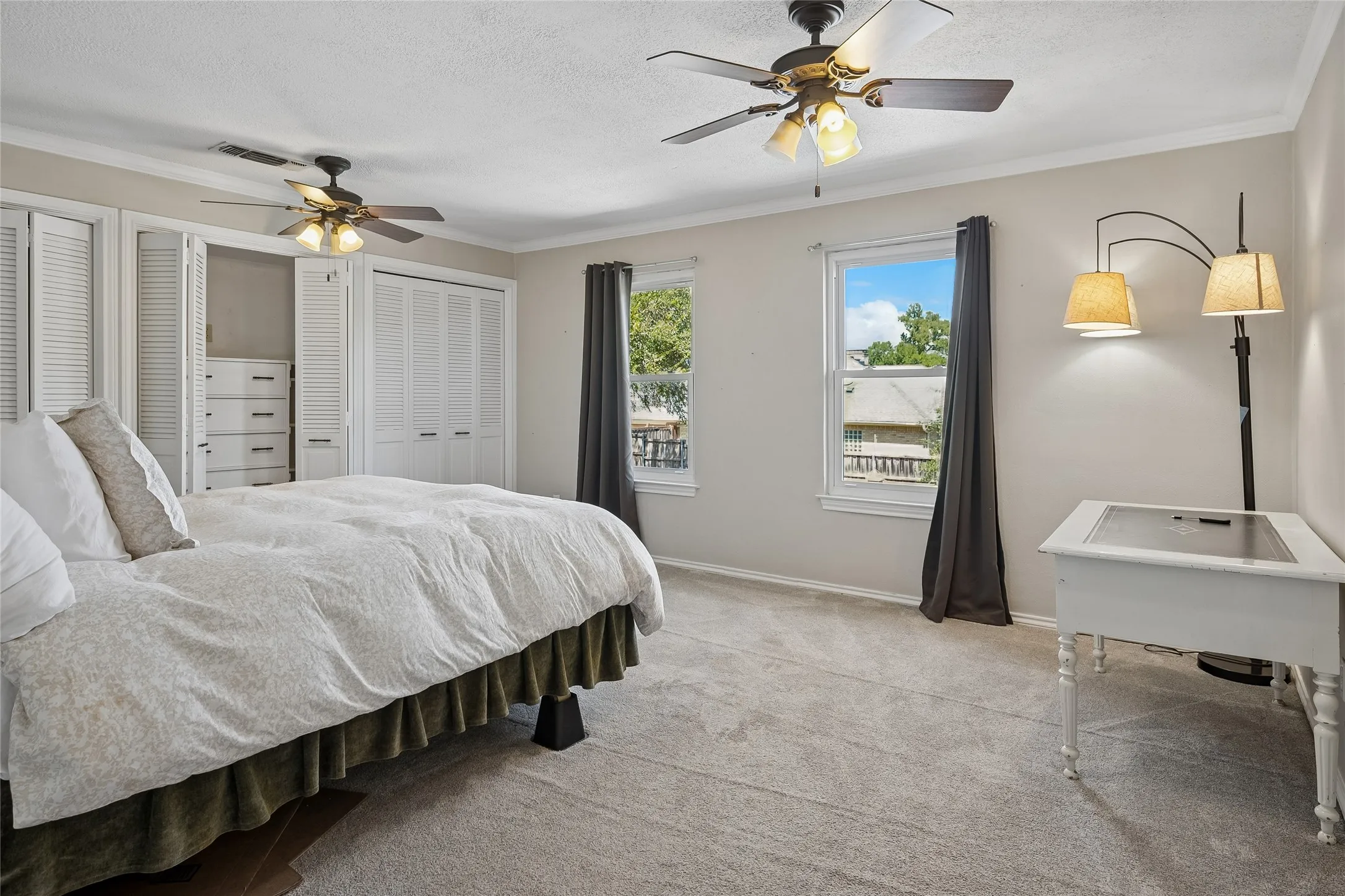 One of the secondary bedrooms with a wall of closet  space