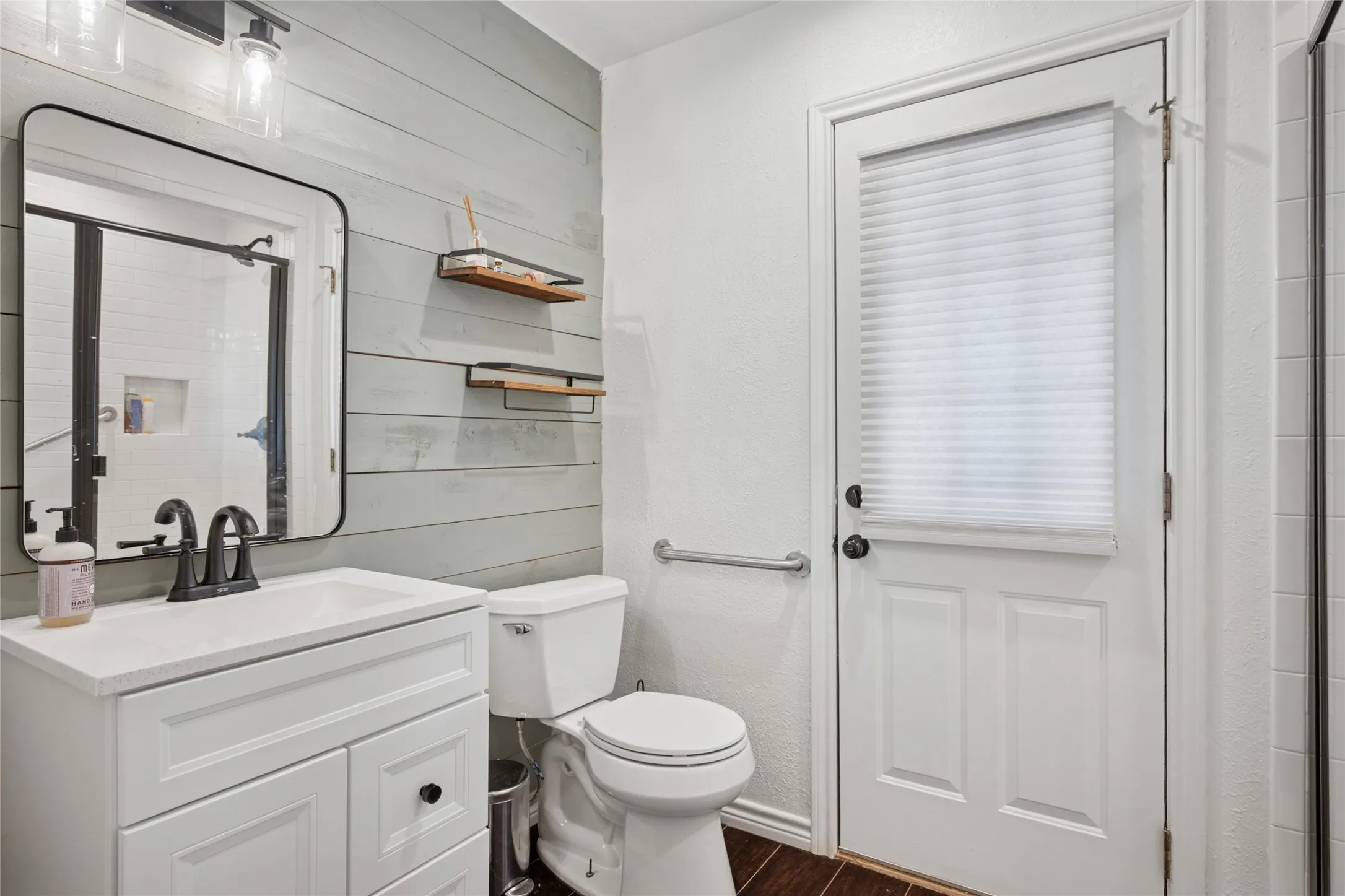 Full bath downstairs opens to the backyard and pool area.