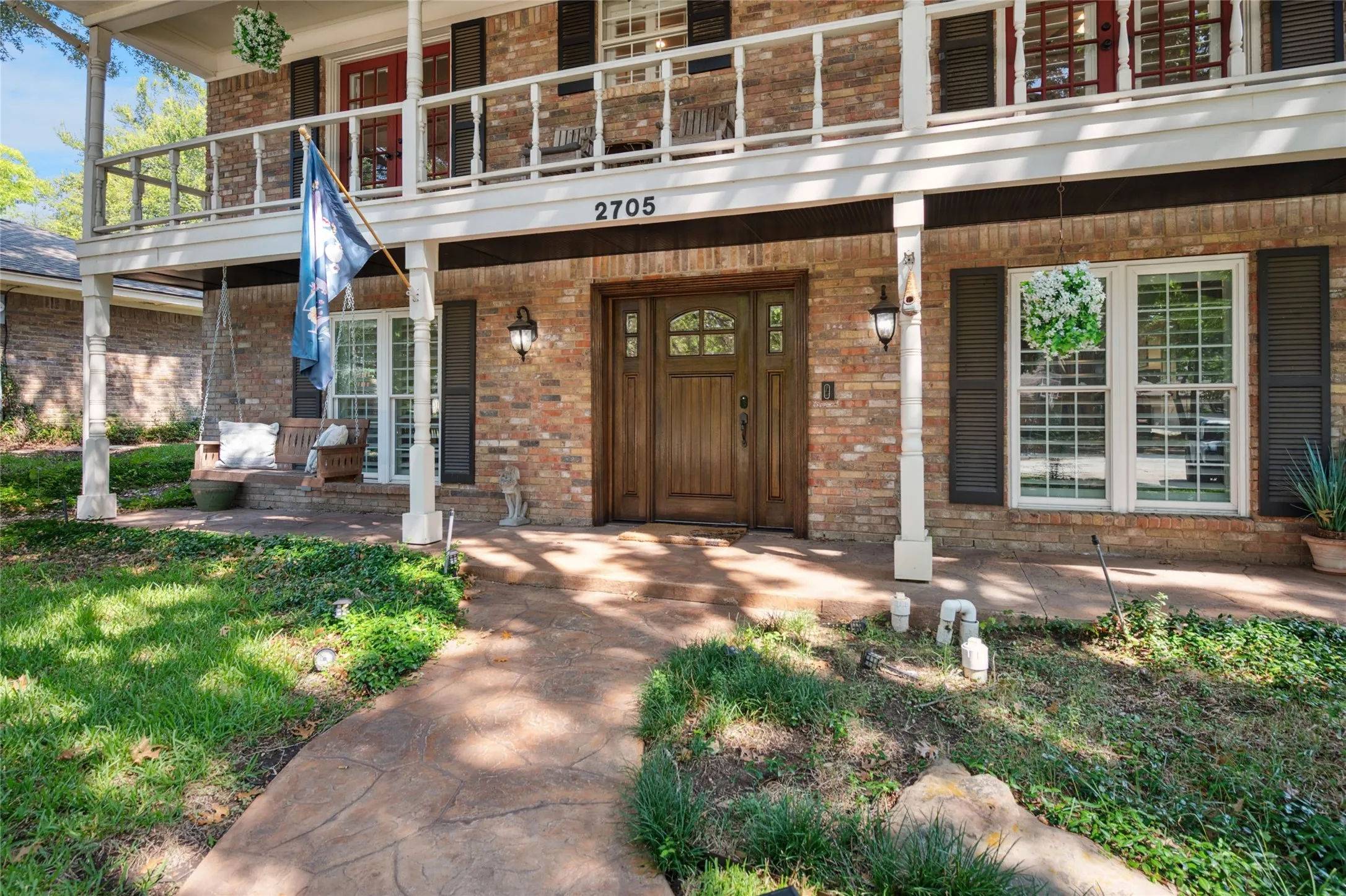 Beautiful front door with shutters accenting the windows