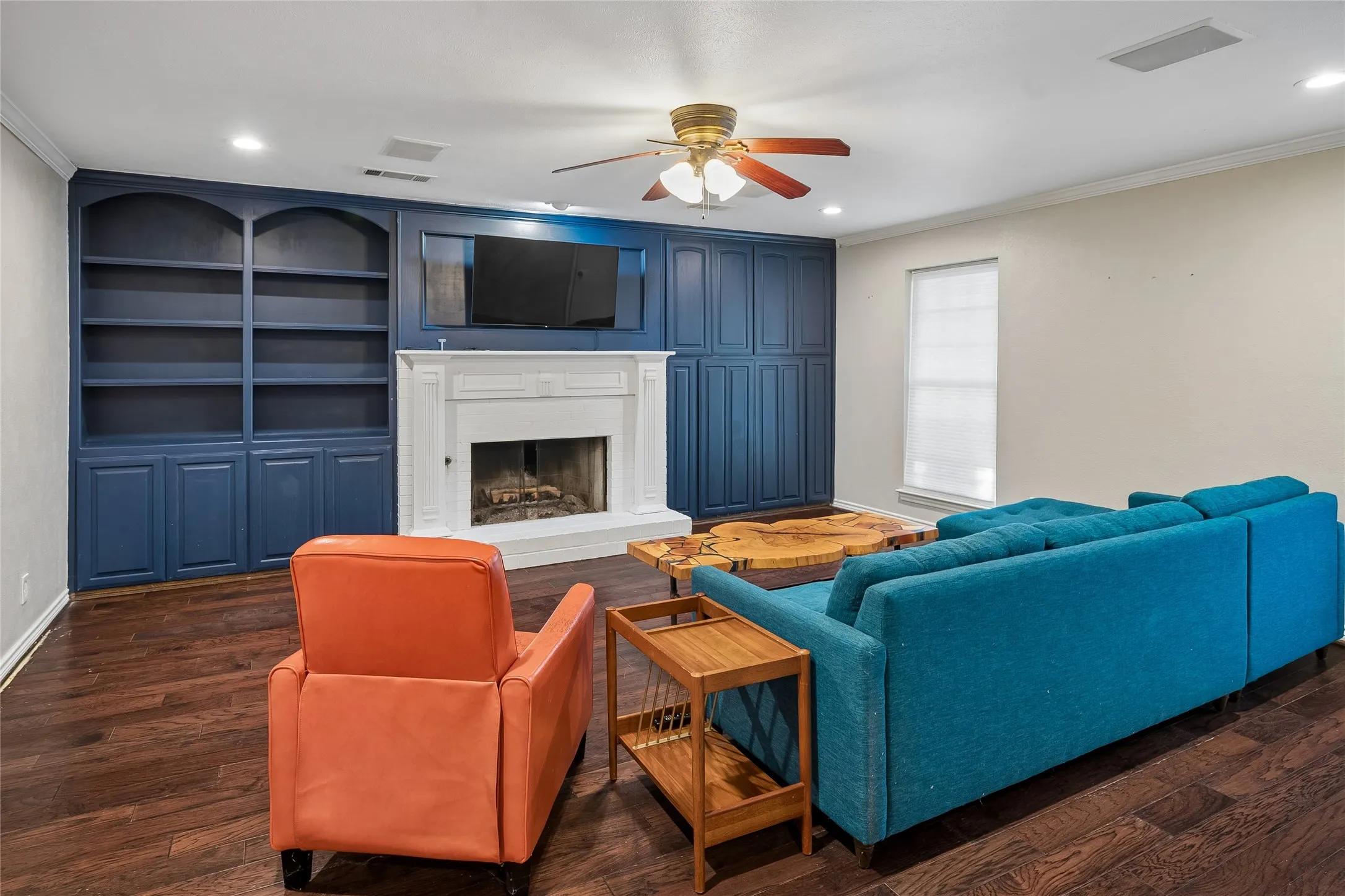 The family room also has wood flooring and a fireplace.