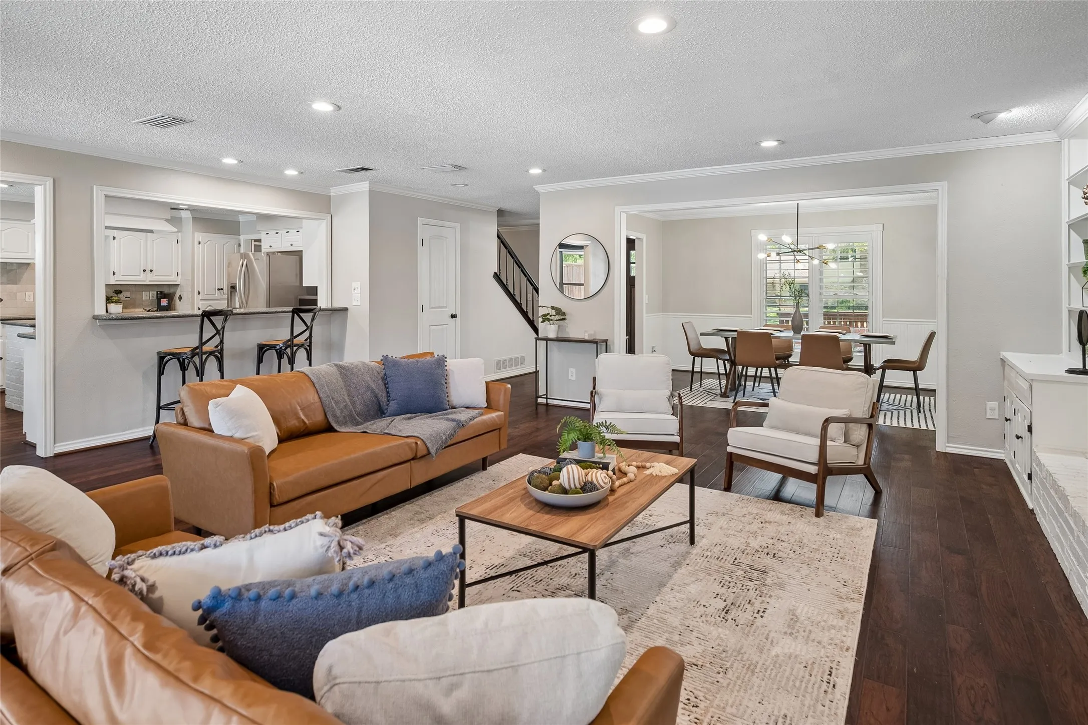 Wood flooring flows through the dining room, foyer, and living room.