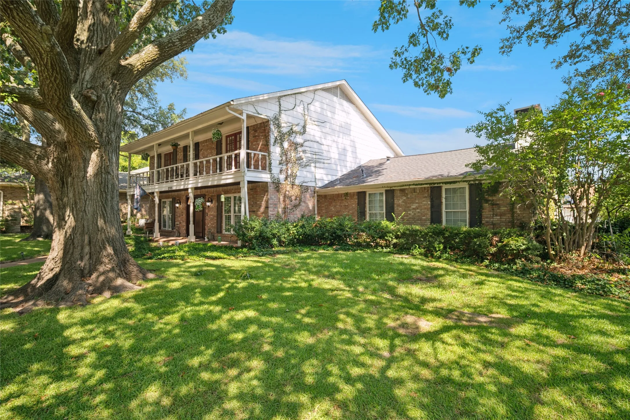 Captivating view from an angle with a majestic tree in the front yard