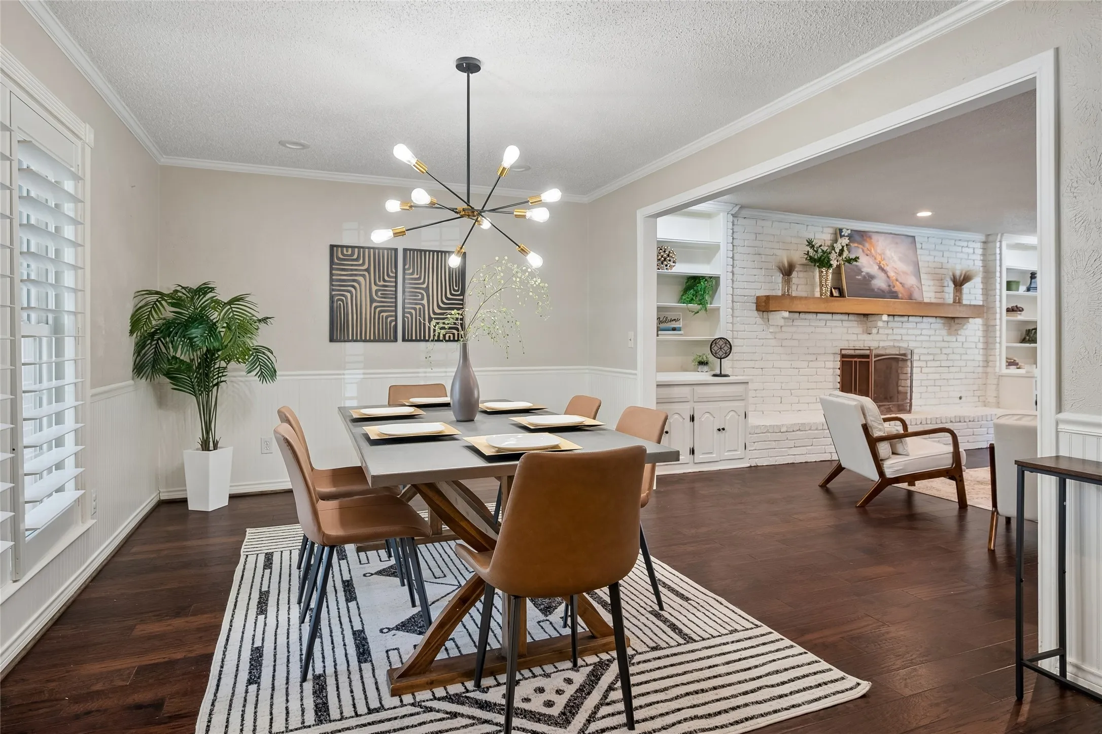 Plantation shutters and a contemporary chandelier accent the dining room.