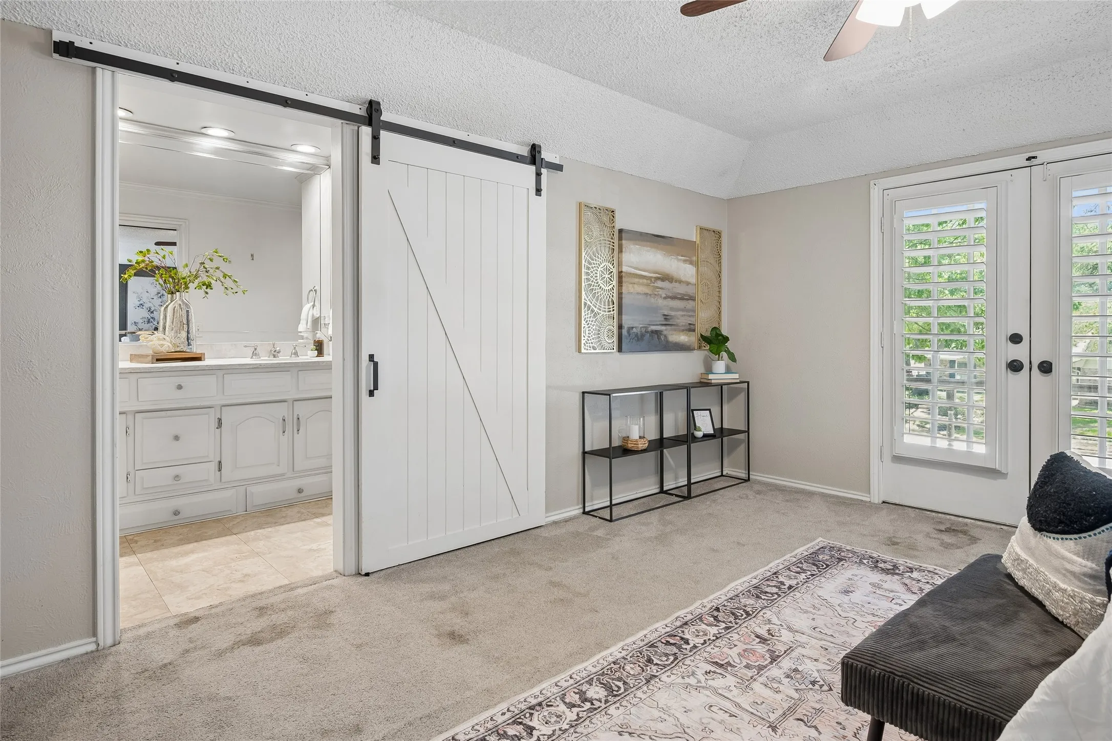 A barn door opens to the primary bathroom.