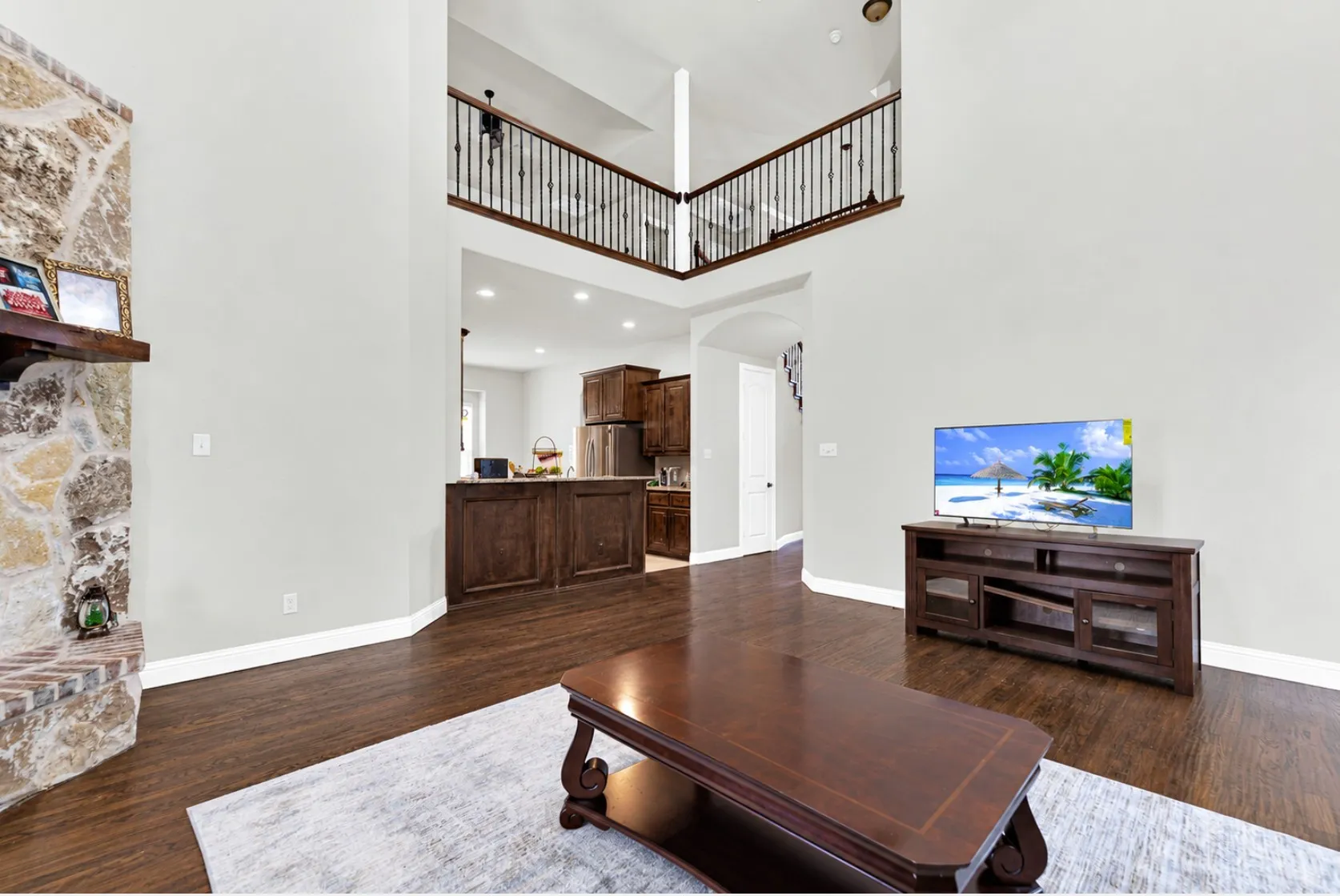 Clean architectural lines and wide arched doorways create an airy flow into the adjoining rooms. You can easily imagine keeping an eye on the family while prepping dinner just steps away.