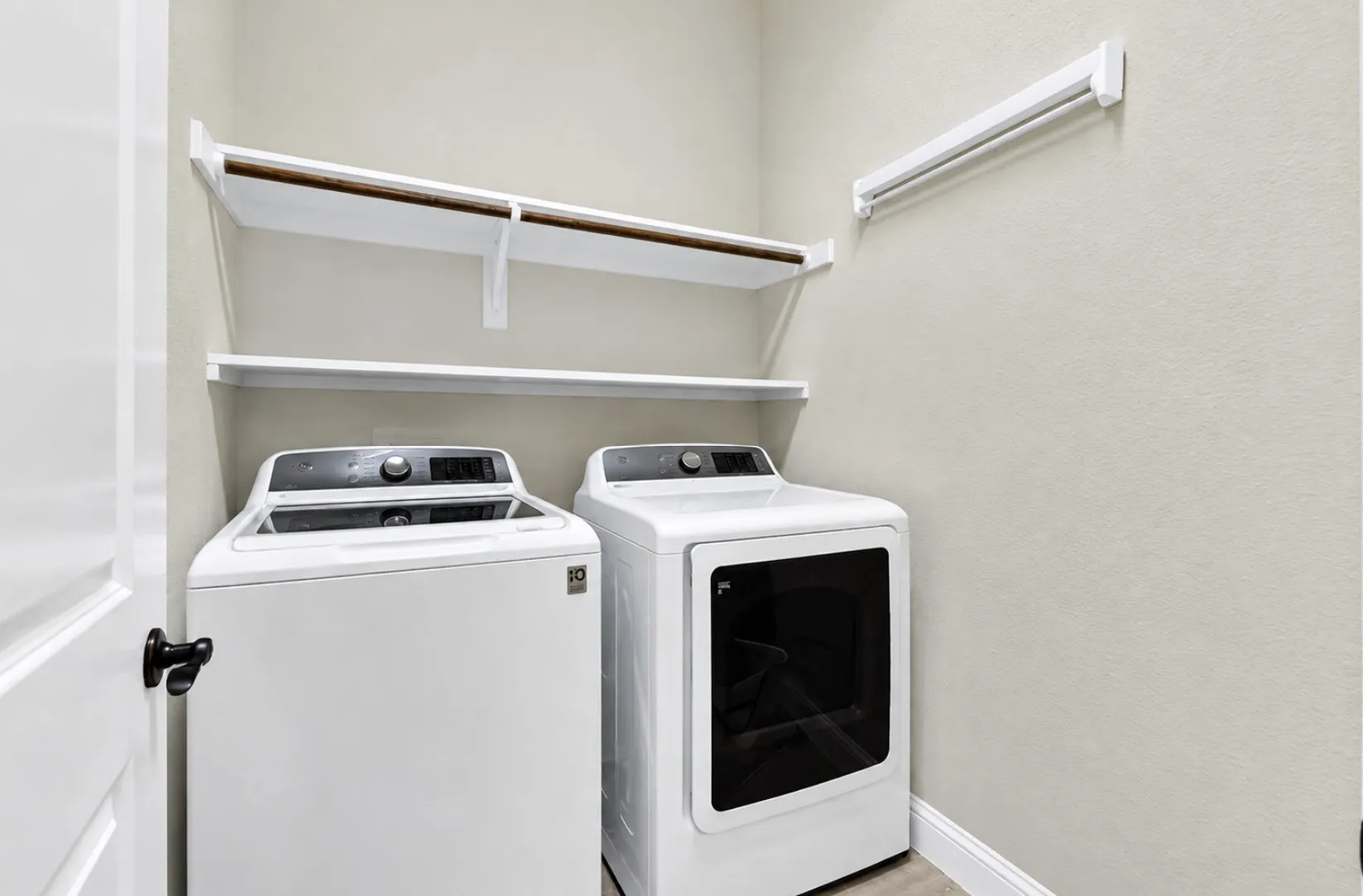 Photo digitally enhanced by AI.  Built-in overhead shelving maximizes vertical space to keep essentials neatly organized within arms reach. It turns everyday chores into a smooth, effortless routine.