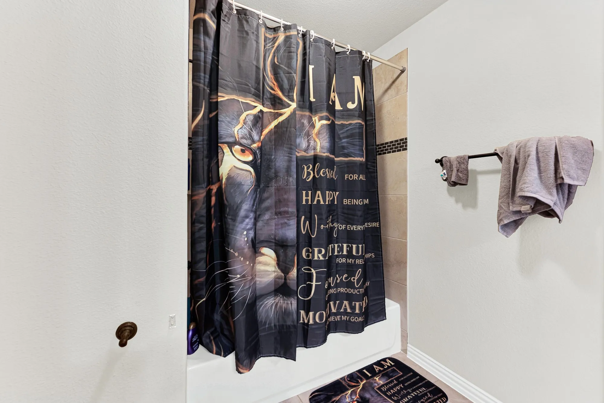 A tub and shower combination with custom accent tiling offers a functional, space-saving design. You will love unwinding with a quick, refreshing wash after a busy afternoon.