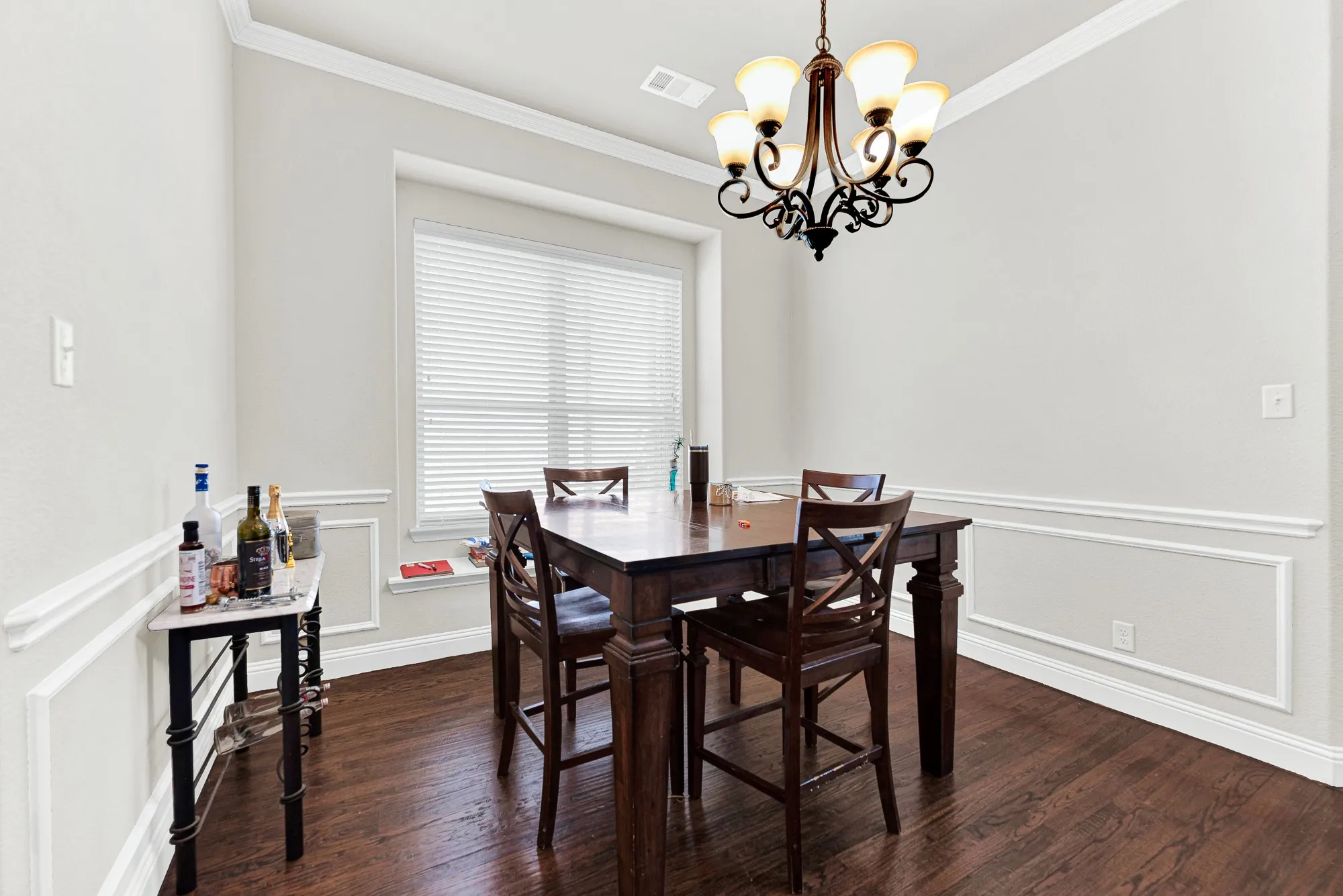 Elegant wainscoting adds a classic, tailored look that visually frames this dedicated entertaining space.
This is the perfect setting for hosting intimate, candlelit dinner parties with your closest friends.