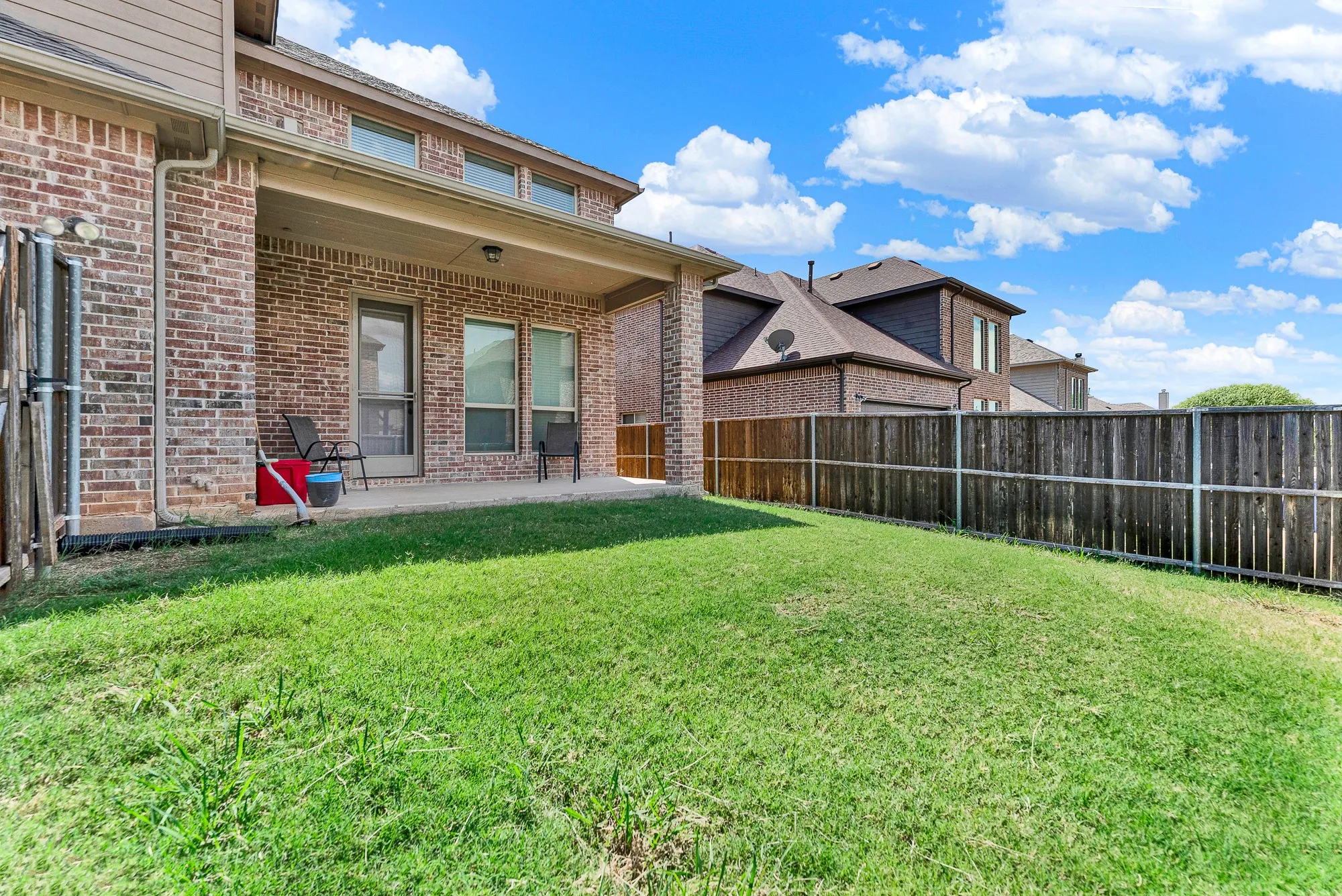 A deep covered patio provides a cool, shaded sanctuary right off the main house. Settle in with a cold drink and enjoy outdoor relaxation no matter the summer heat.