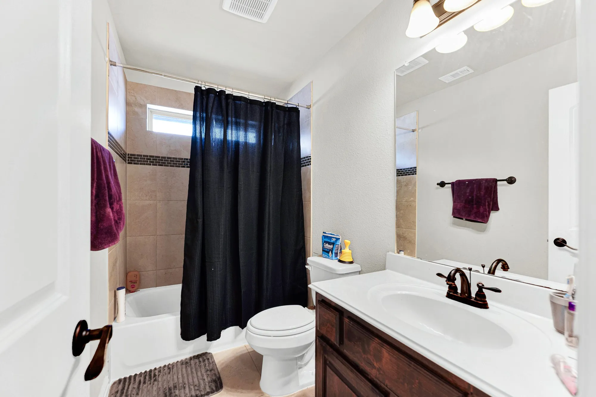A high horizontal window over the shower enclosure draws in gentle top lighting while keeping the layout private. It is just what you need for a quick prep before heading out the door for weekend errands.