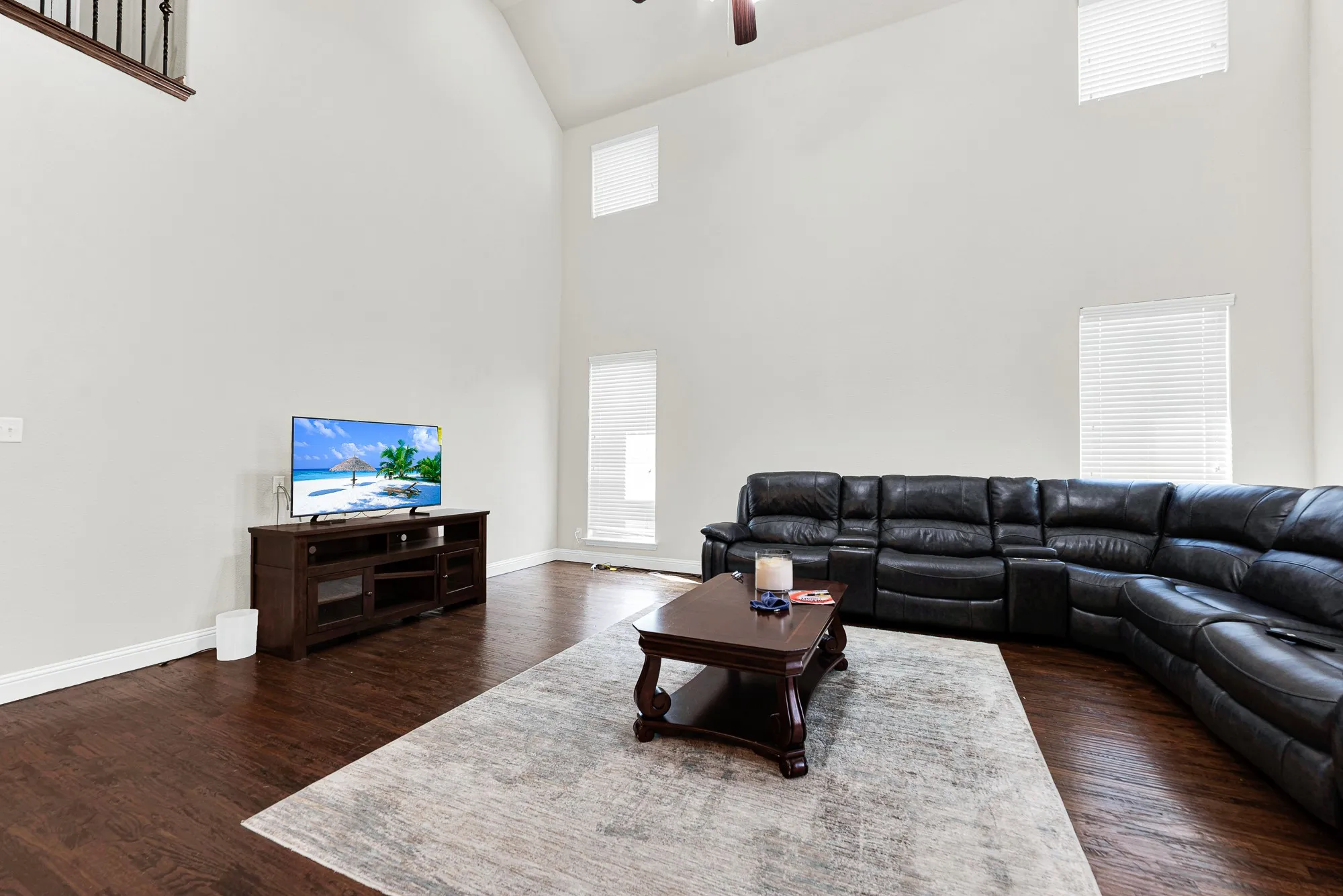 Stacked two-story windows flood the rich wood floors with soft, glowing sunlight throughout the day. Start your morning right here, sipping hot coffee while watching the early light pour in.