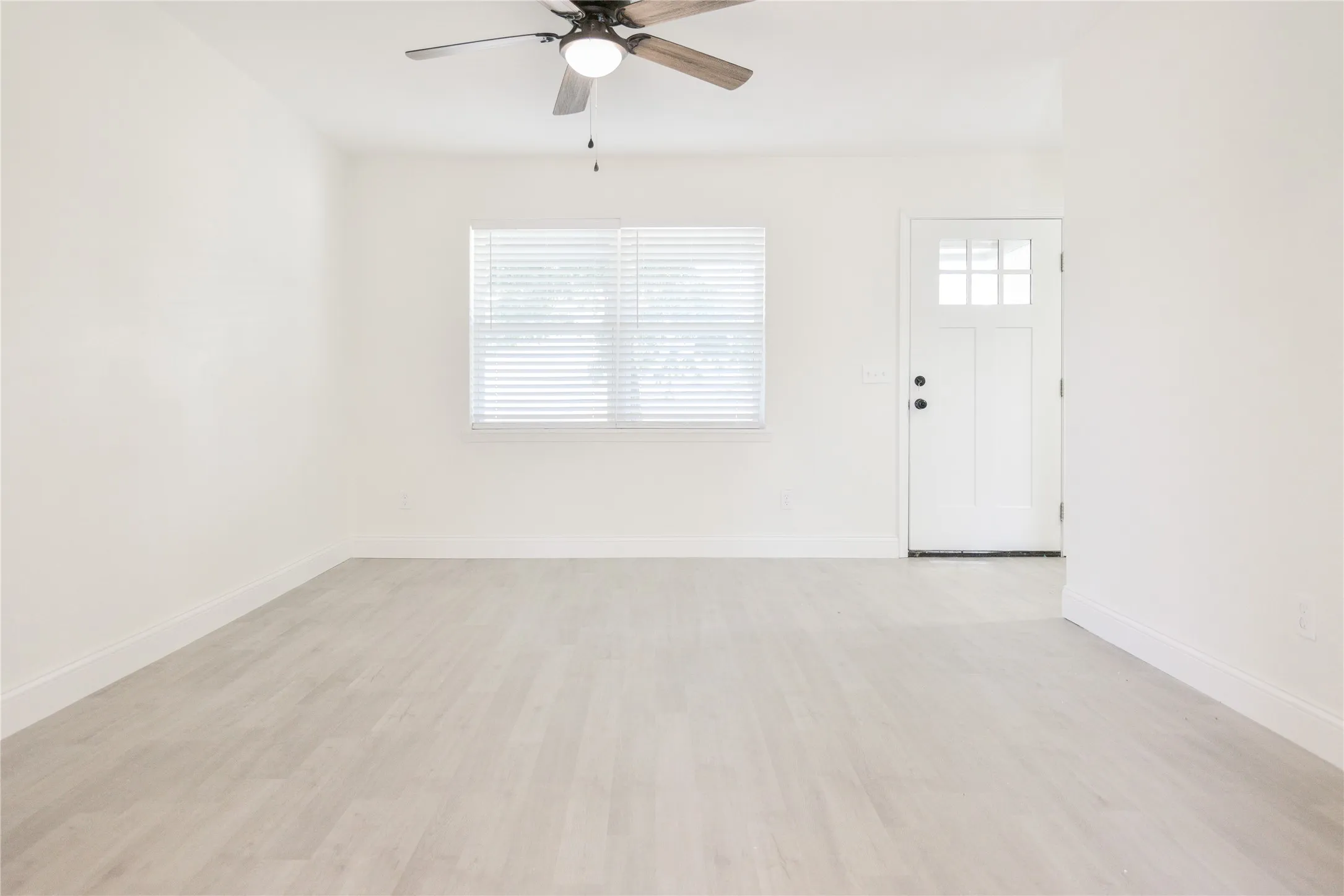 Neutral wall tones and light wood-finish flooring