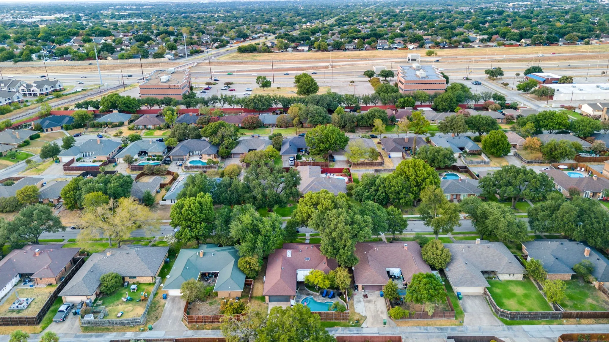Residential neighborhood with varied rooflines and mature trees, just south of Bush Turnpike