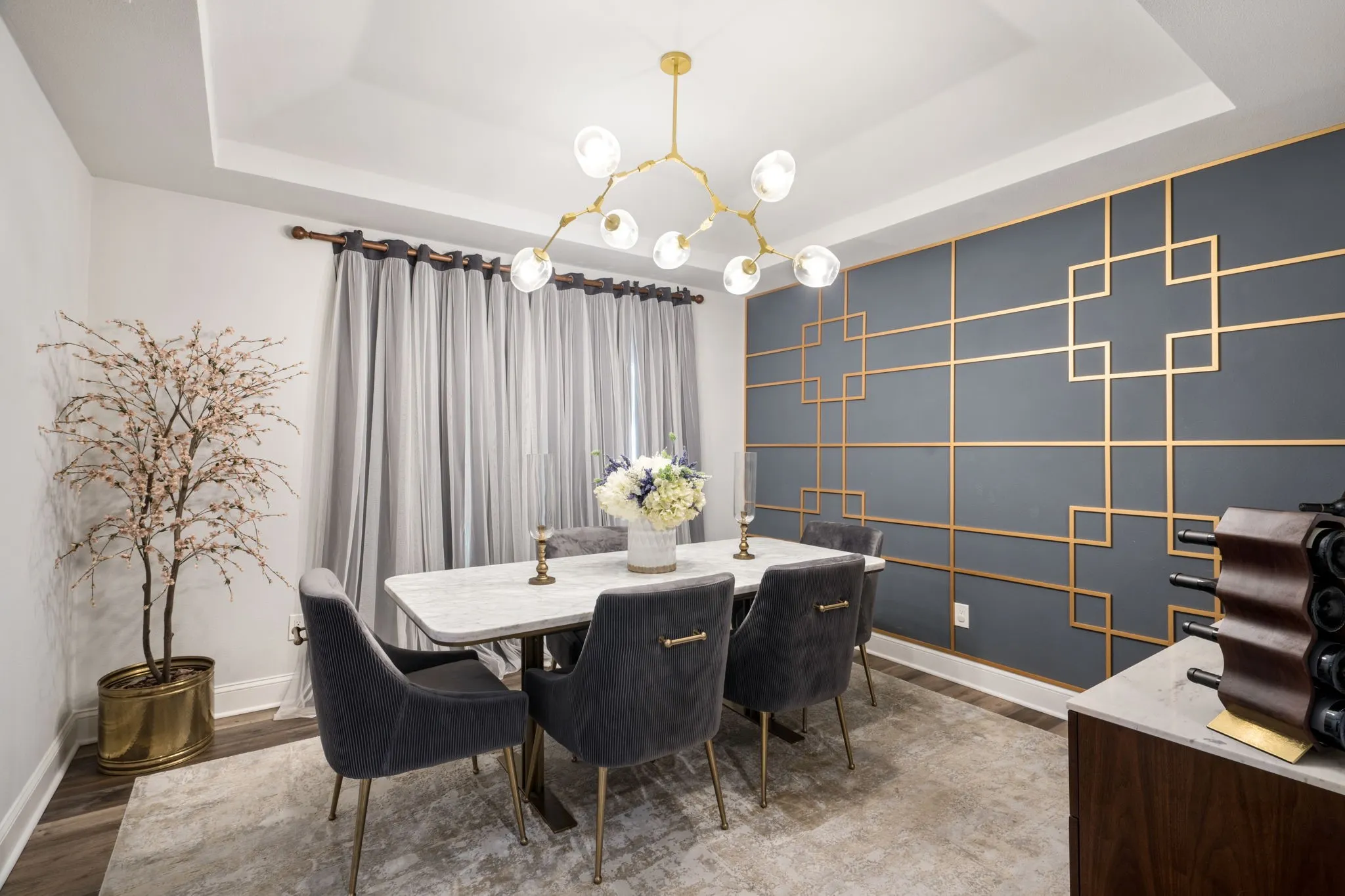 dinning room with custom accent wall, vaulted ceilings and decorative lighting.