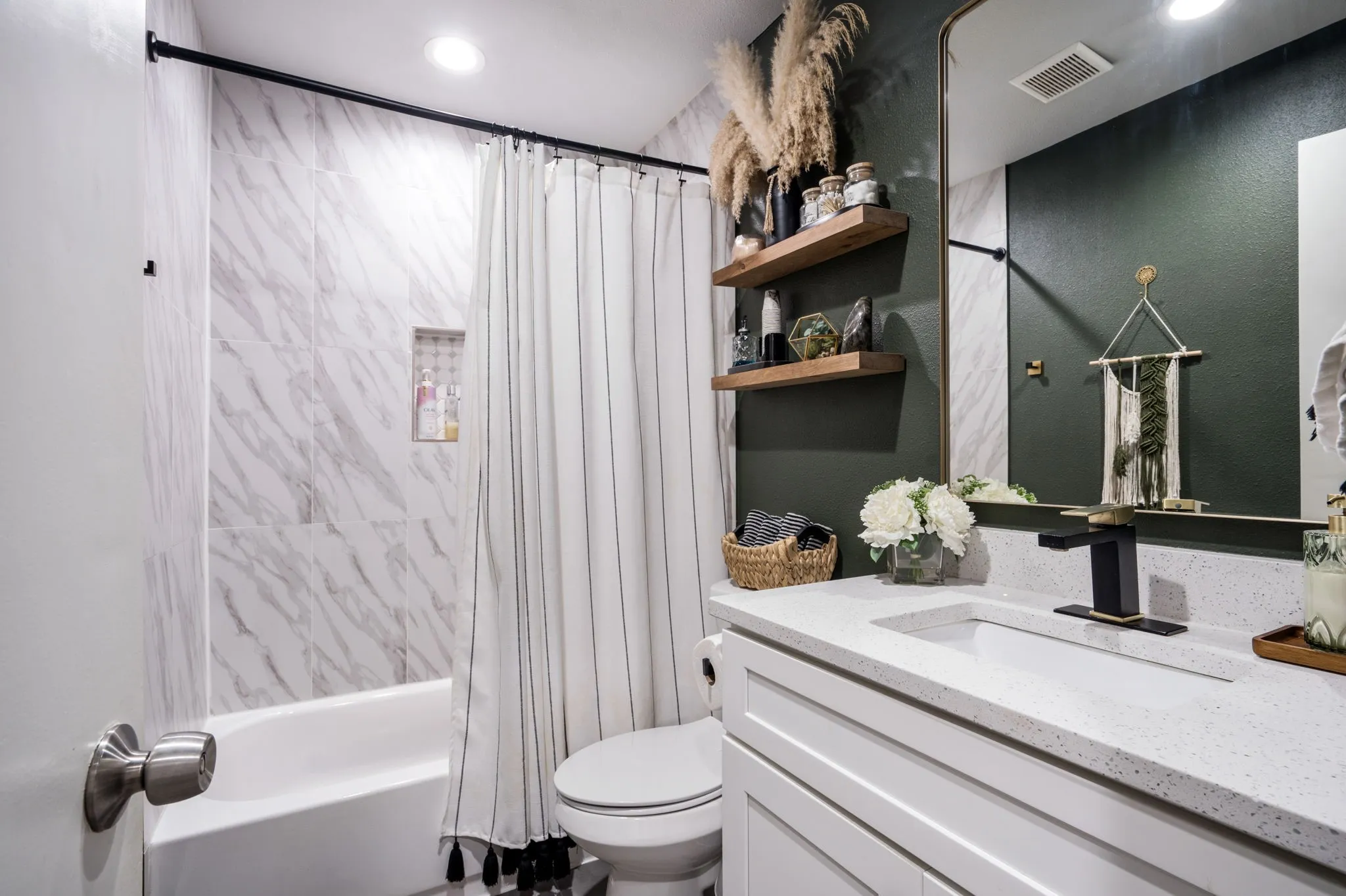 Spa-inspired bathroom featuring a white quartz countertop with an undermount sink, matte black faucet, and floating vanity with soft-close drawers